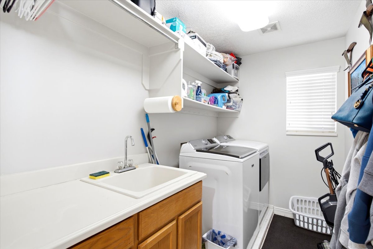 Laundry area featuring white walls and built-in shelving