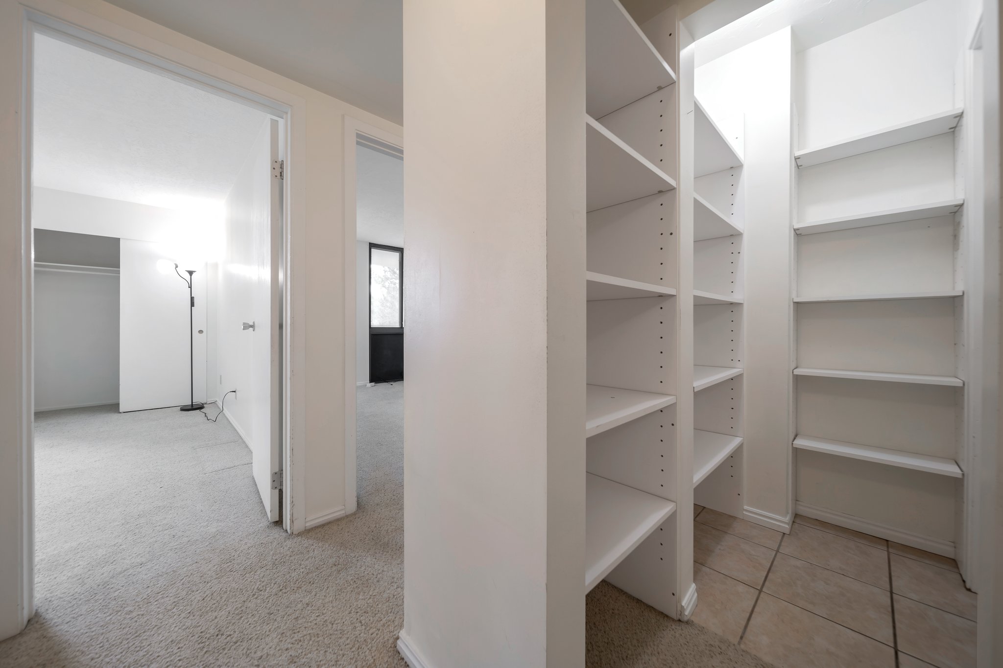 Walk-in closet with extensive built-in shelving, providing ample storage