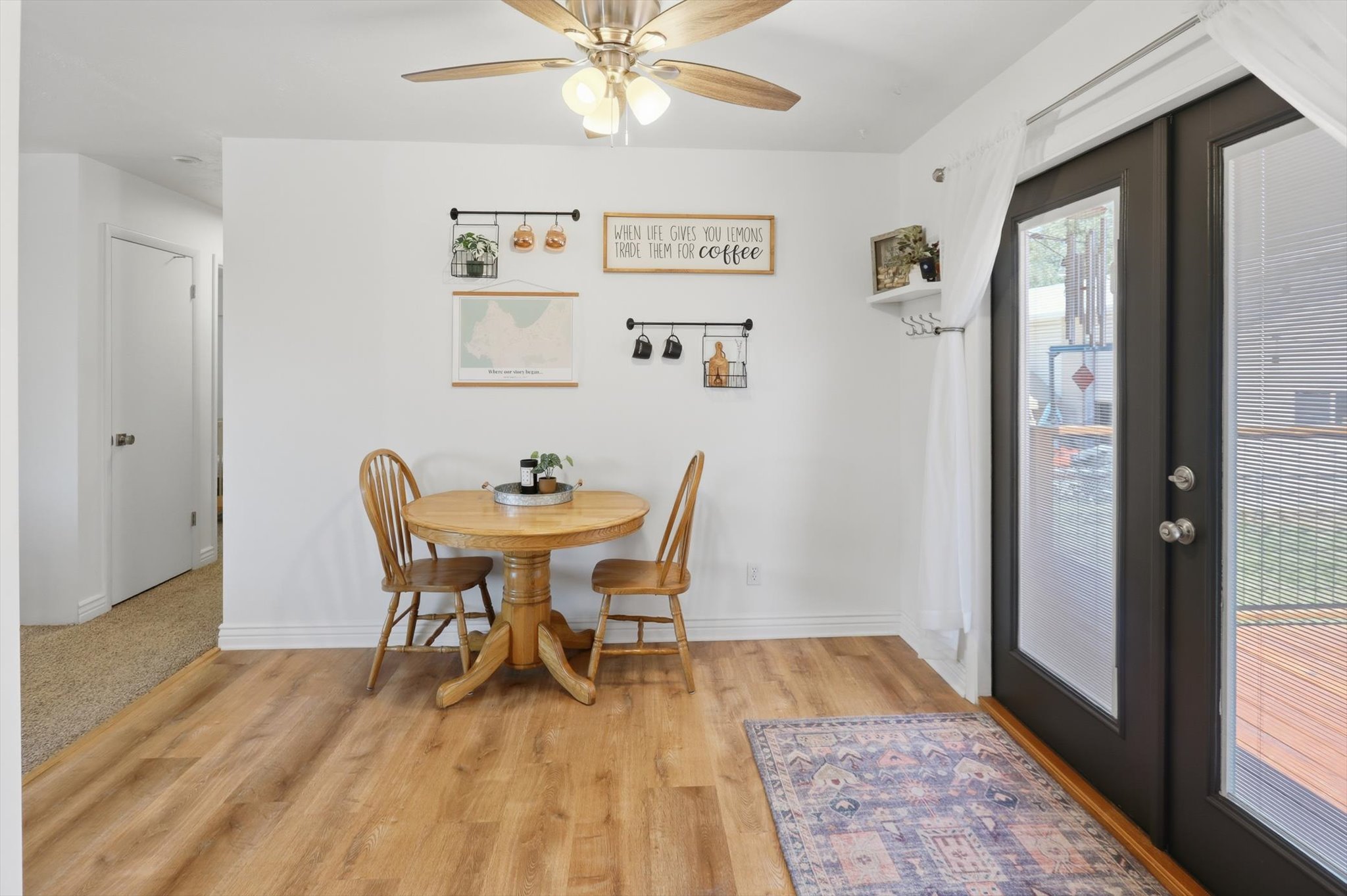 Hardwood-style flooring throughout, complemented by a ceiling fan with integrated lighting