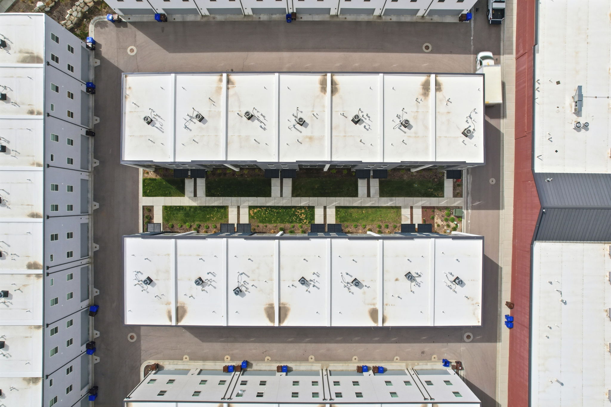 Modern multi-unit property with flat roofs and rooftop HVAC units
