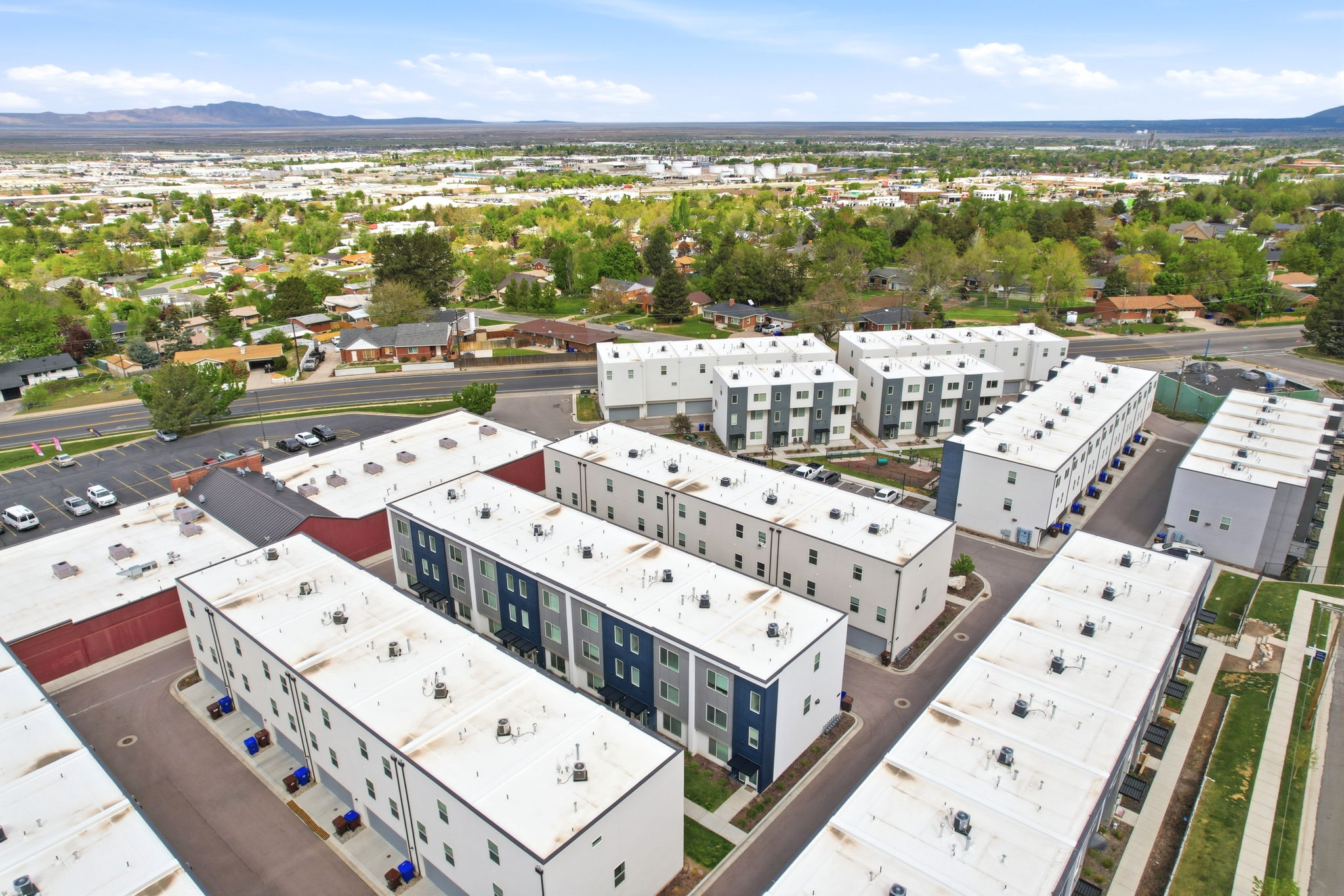 Aerial perspective showcasing multiple modern residential buildings with flat roofs and multi-toned facades