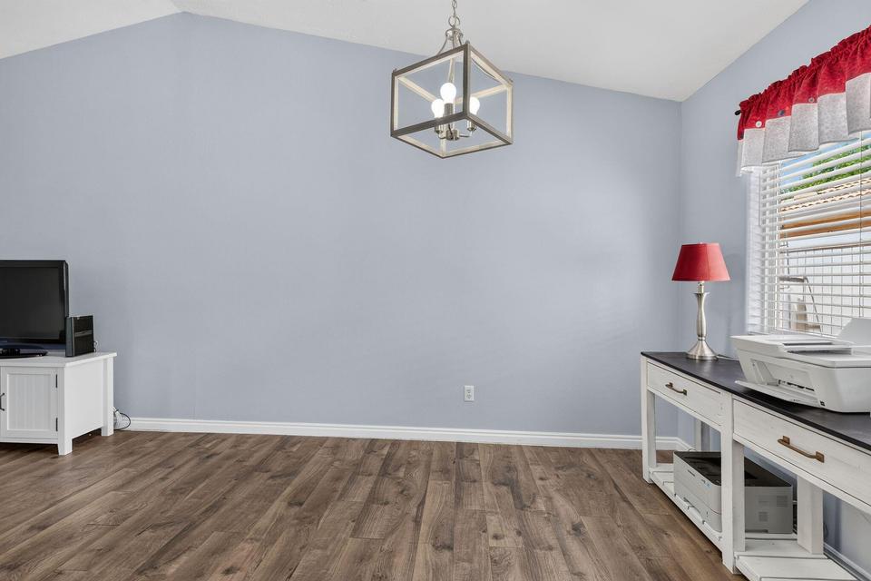 Vaulted ceilings complement the wood-finish flooring in this room