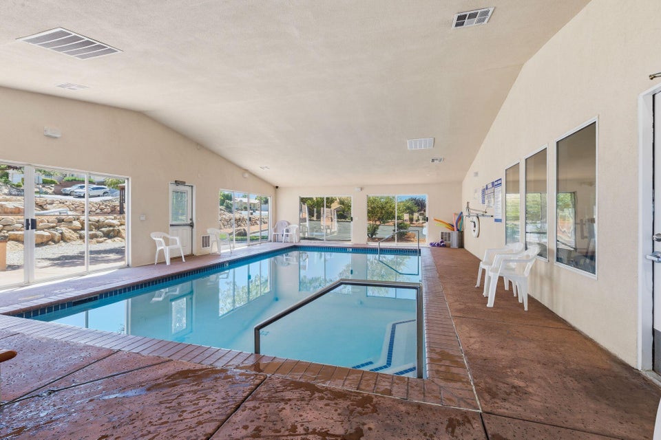 Indoor swimming pool featuring a built-in spa