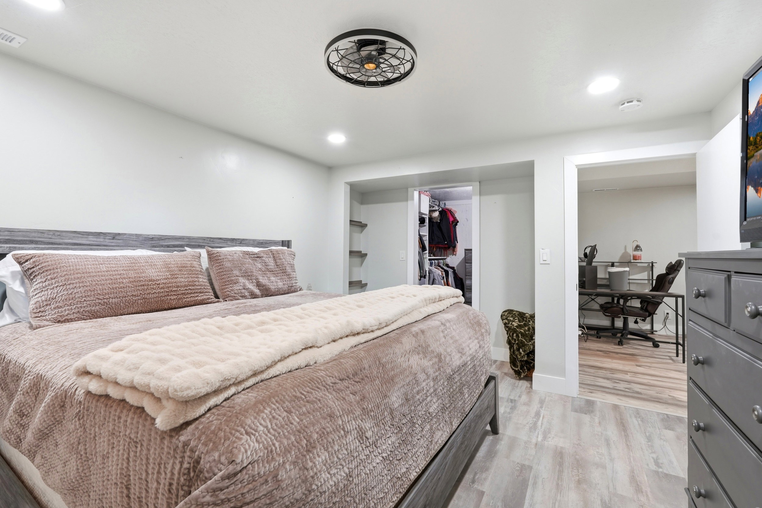 Bedroom featuring wood-finish flooring, recessed lighting, a modern ceiling fan, and a built-in closet with shelving