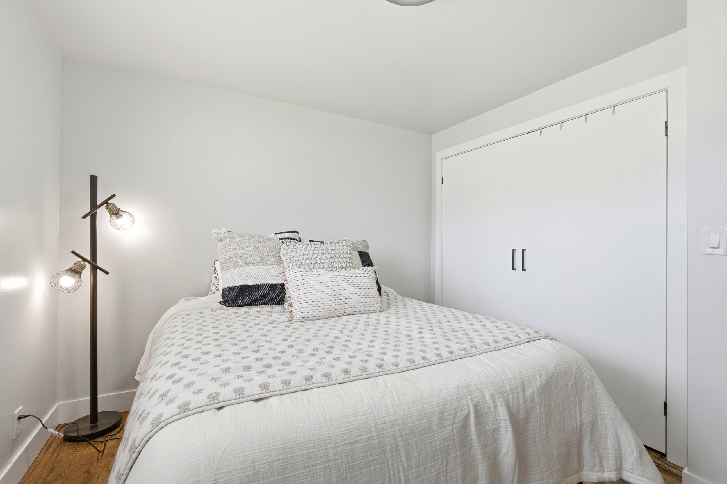 Bedroom featuring wood-finish flooring, white walls, and a recessed ceiling light