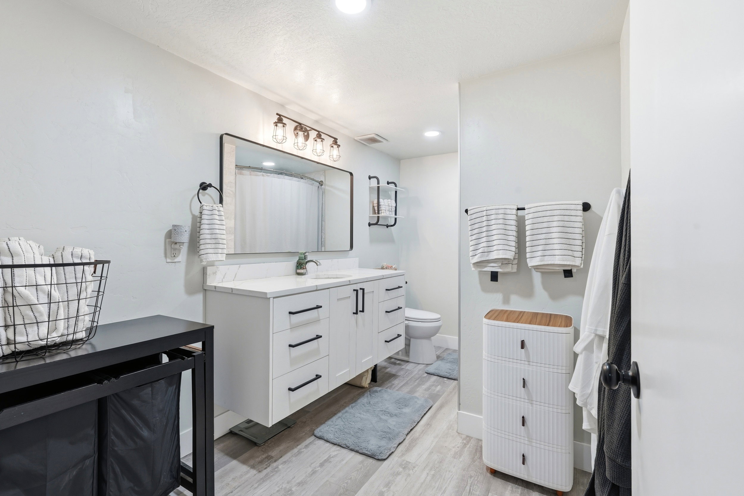 Floating vanity with a white countertop and rectangular undermount sink