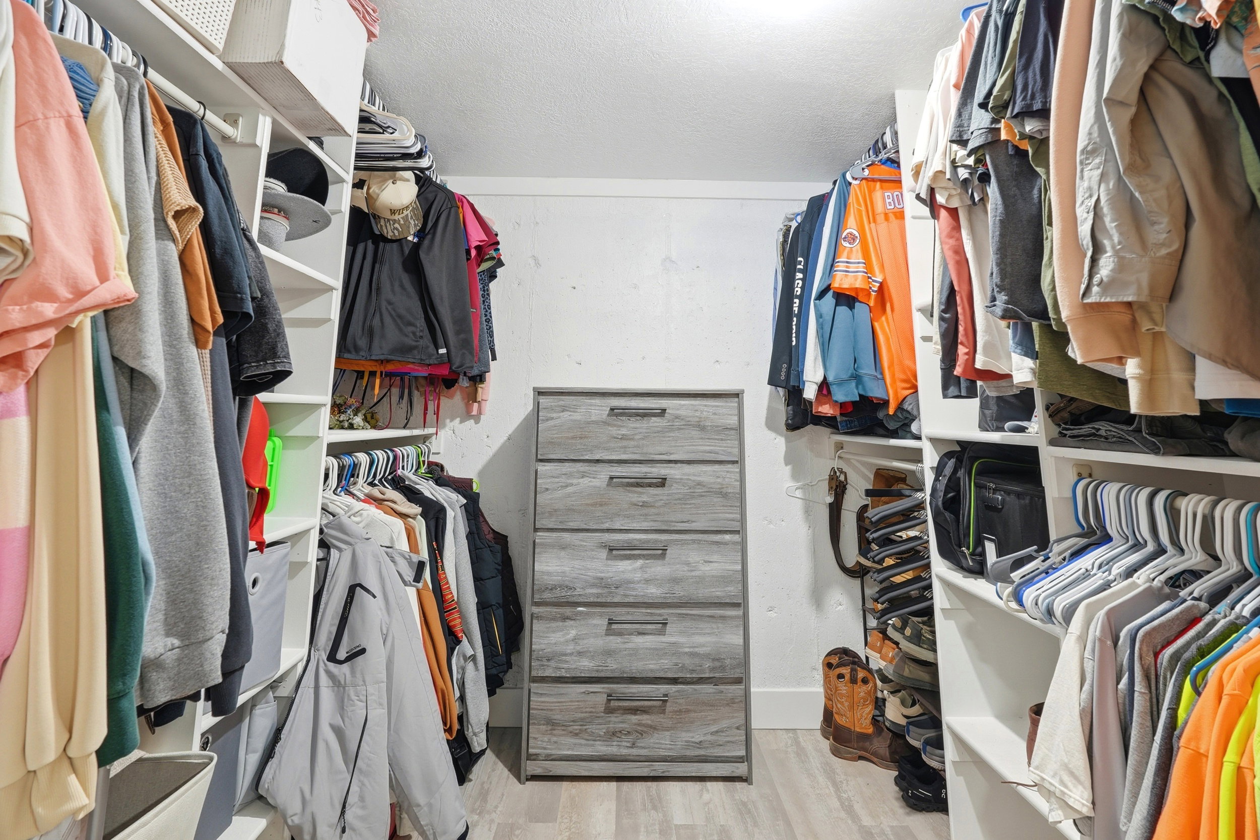 Walk-in closet featuring built-in shelving and hanging storage