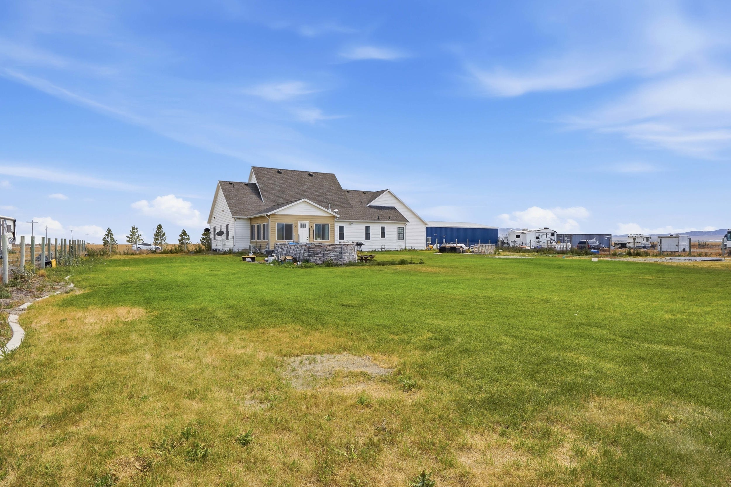 Spacious rear yard with a perimeter fence and mature landscaping