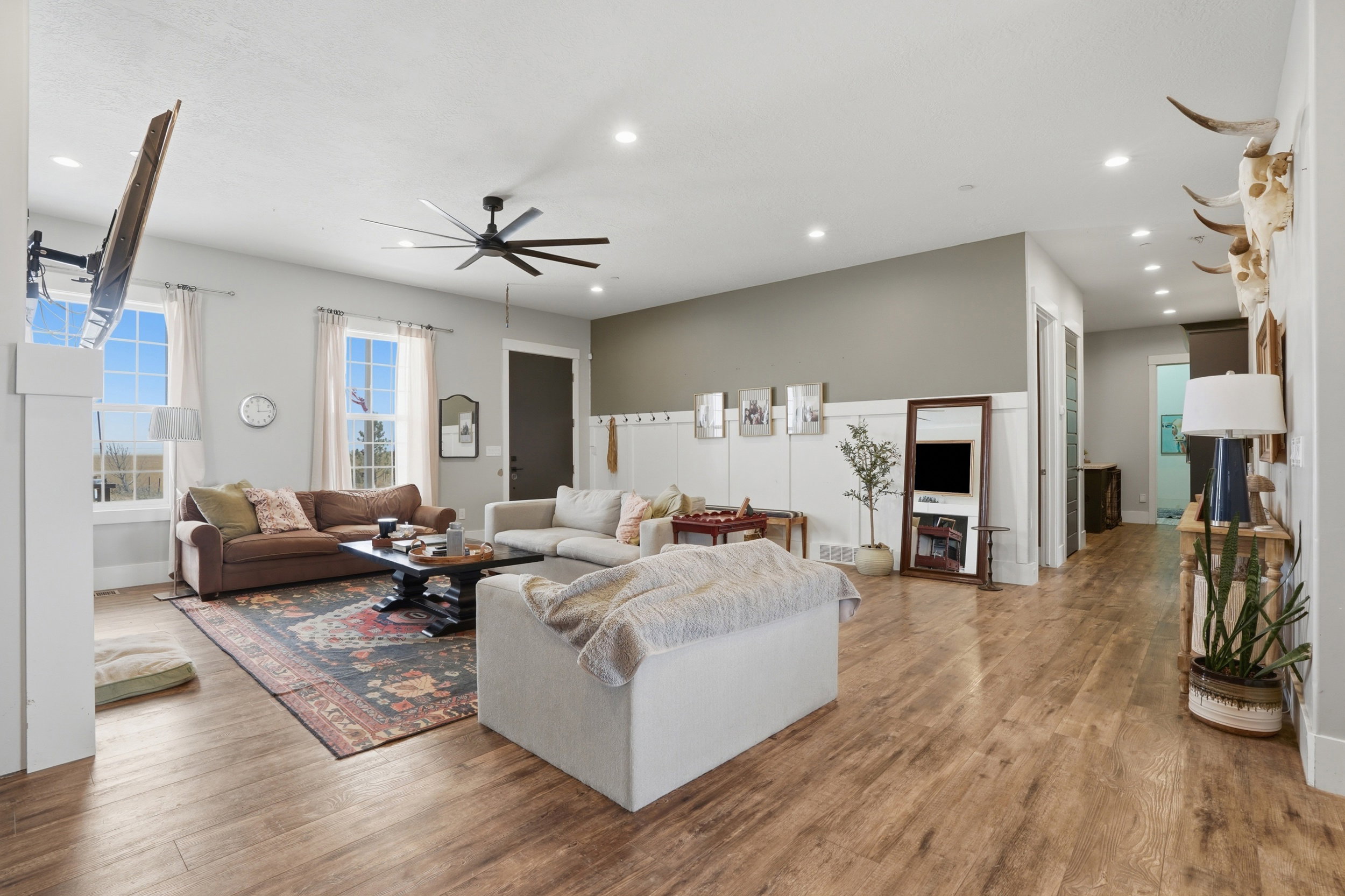 Open-concept living area featuring wood-finish flooring, recessed lighting, and a contemporary ceiling fan