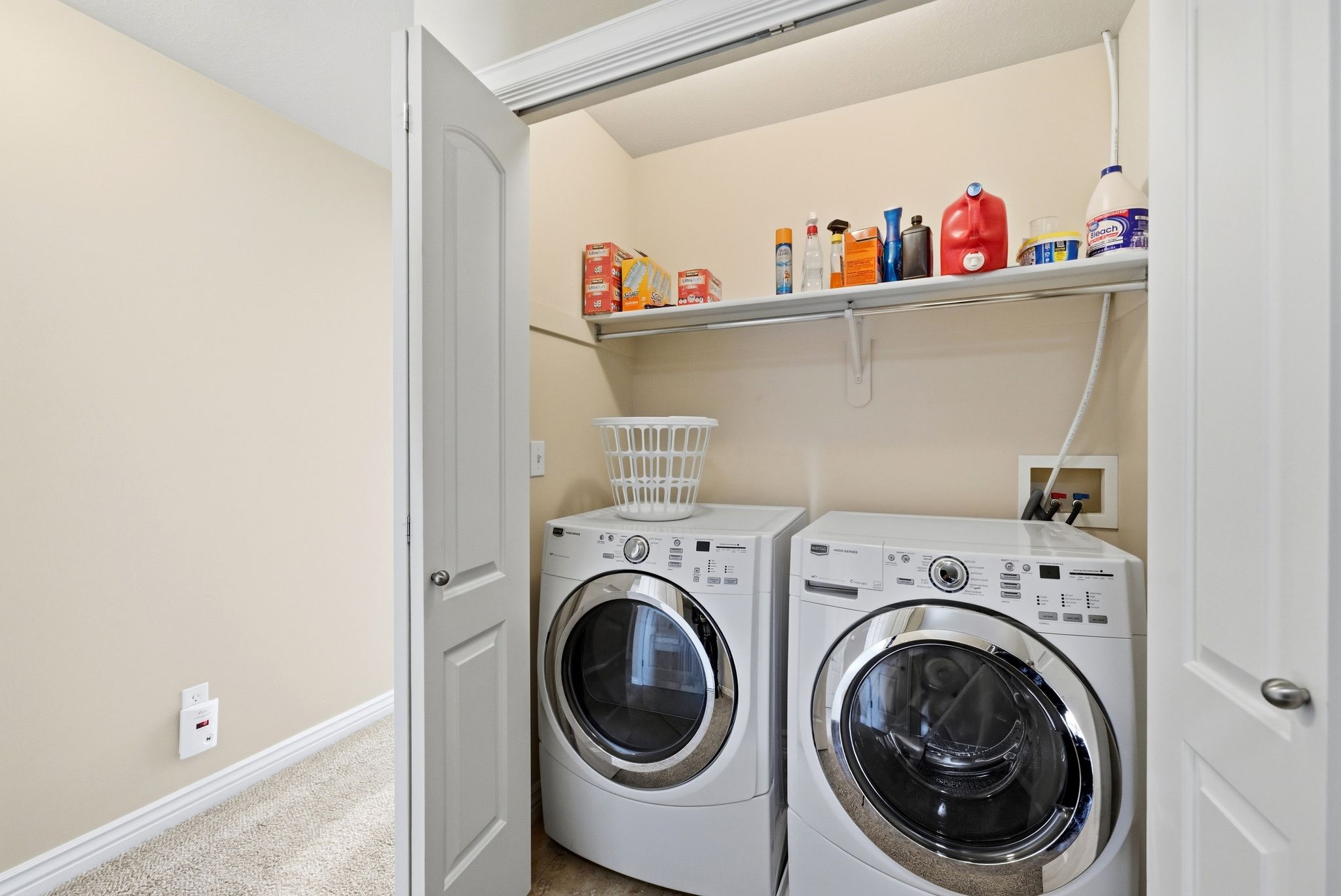 Laundry area featuring carpet floors and washing machine and clothes dryer