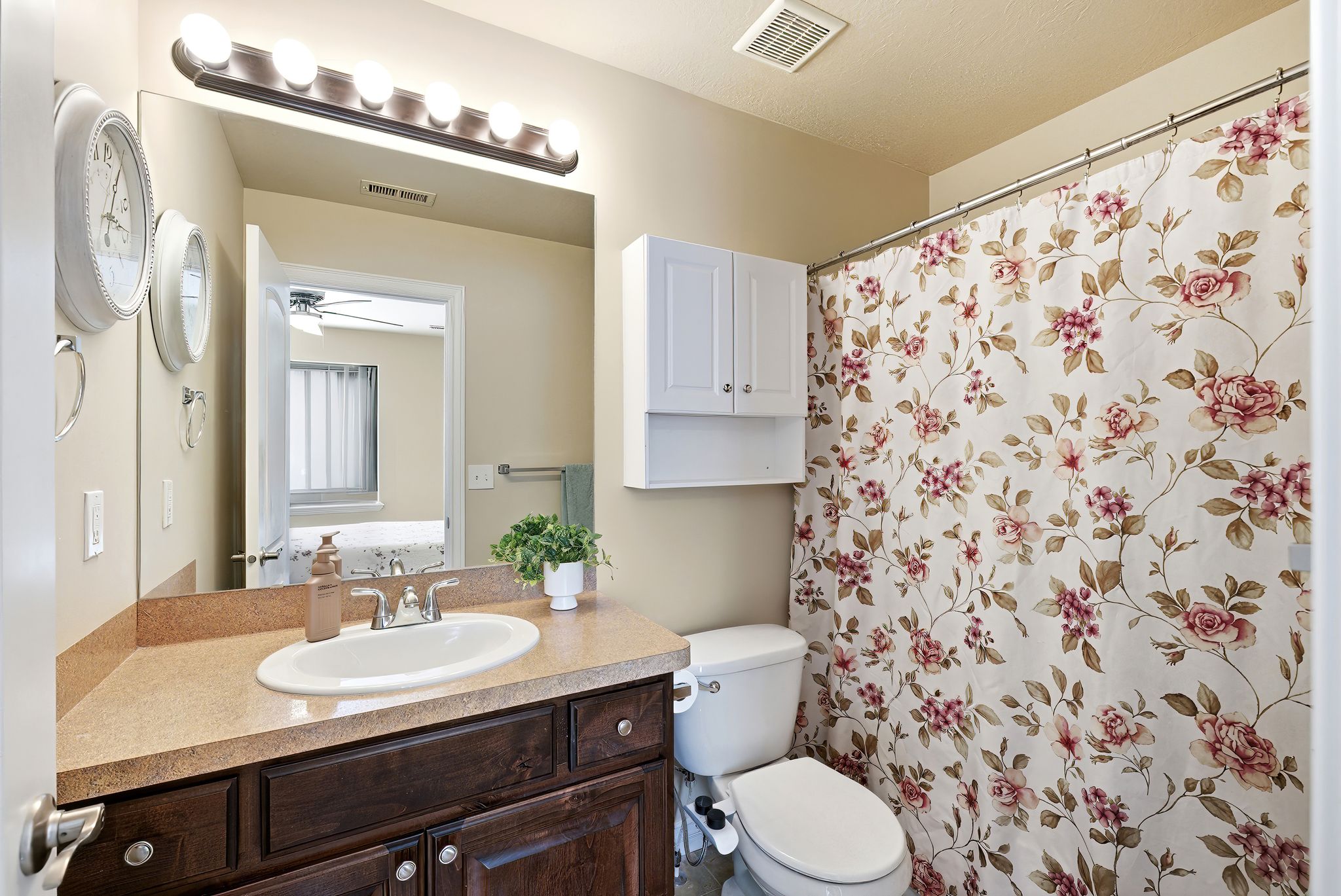 Primary Bathroom featuring vanity, a shower with curtain, and ensuite bathroom