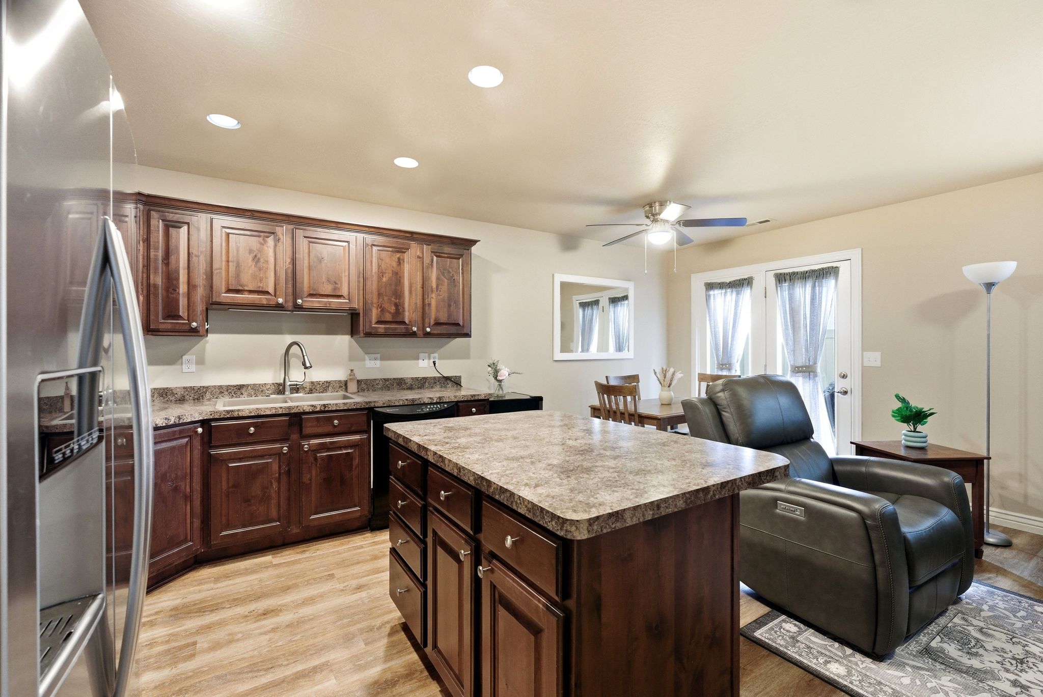 Kitchen, a kitchen island, light wood-style floors, ceiling fan, and recessed lighting