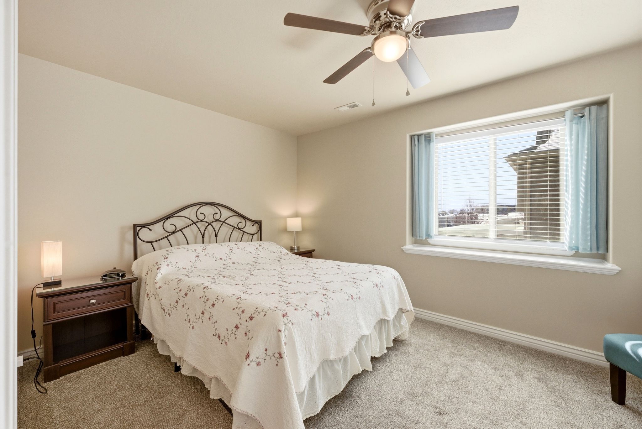 Primary Bedroom featuring light colored carpet and a ceiling fan