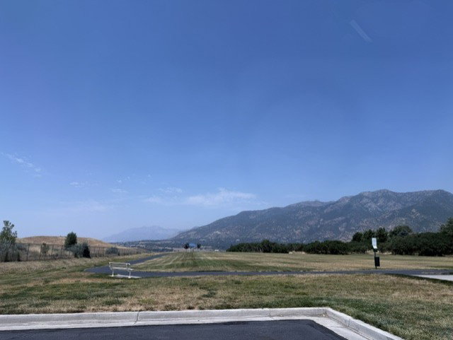 Expansive natural landscape featuring distant mountains and a clear sky