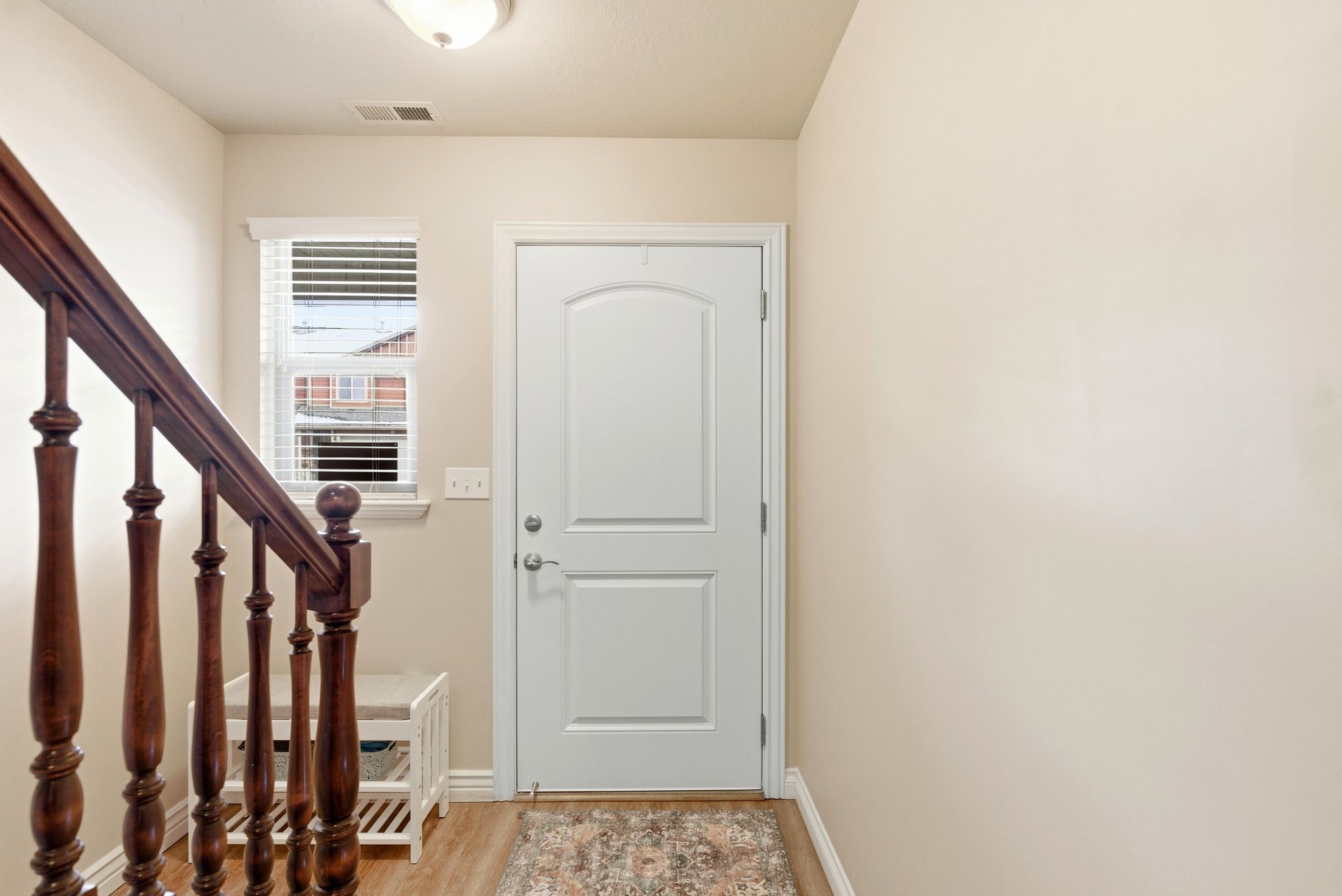 Foyer entrance featuring light wood finished floors and baseboards