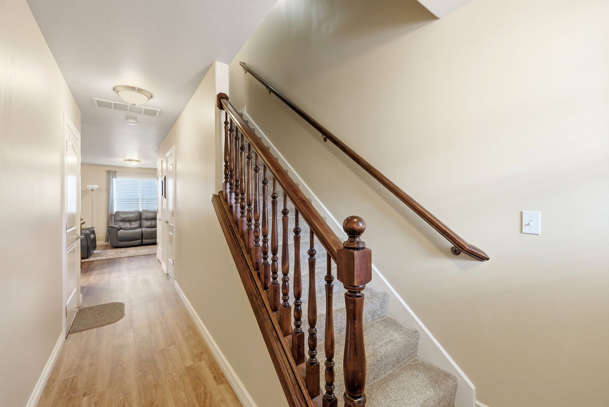 Staircase featuring baseboards and wood finished floors