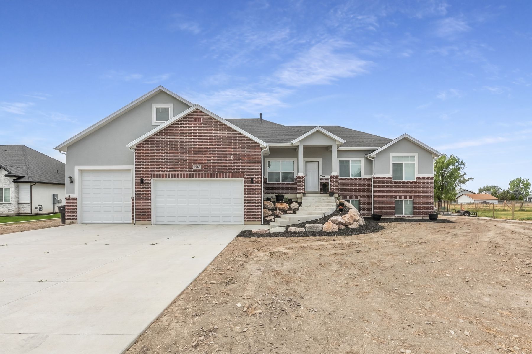 Modern two-story residence featuring a brick and stucco exterior