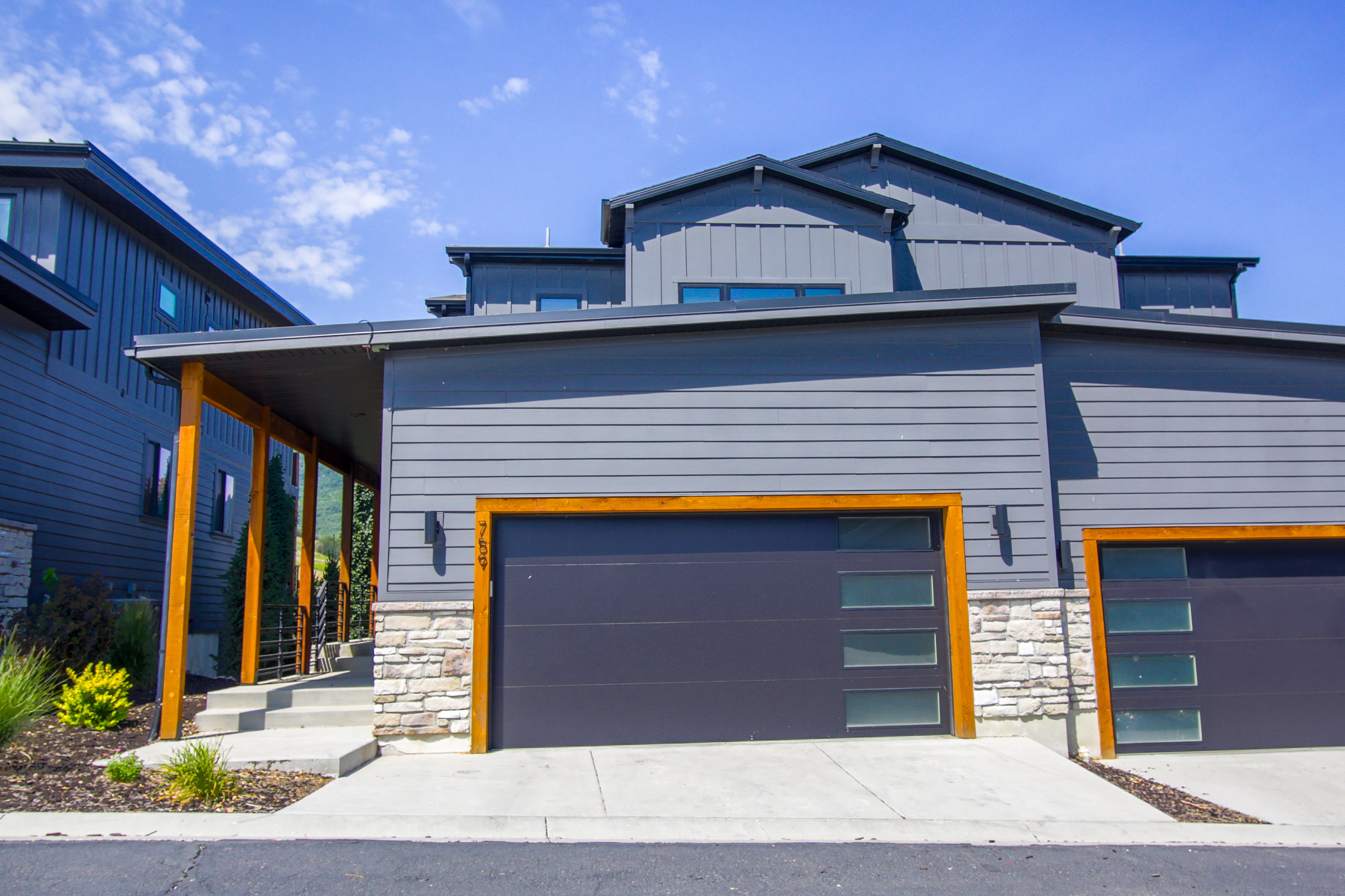 Modern architectural design featuring horizontal siding and stone accents