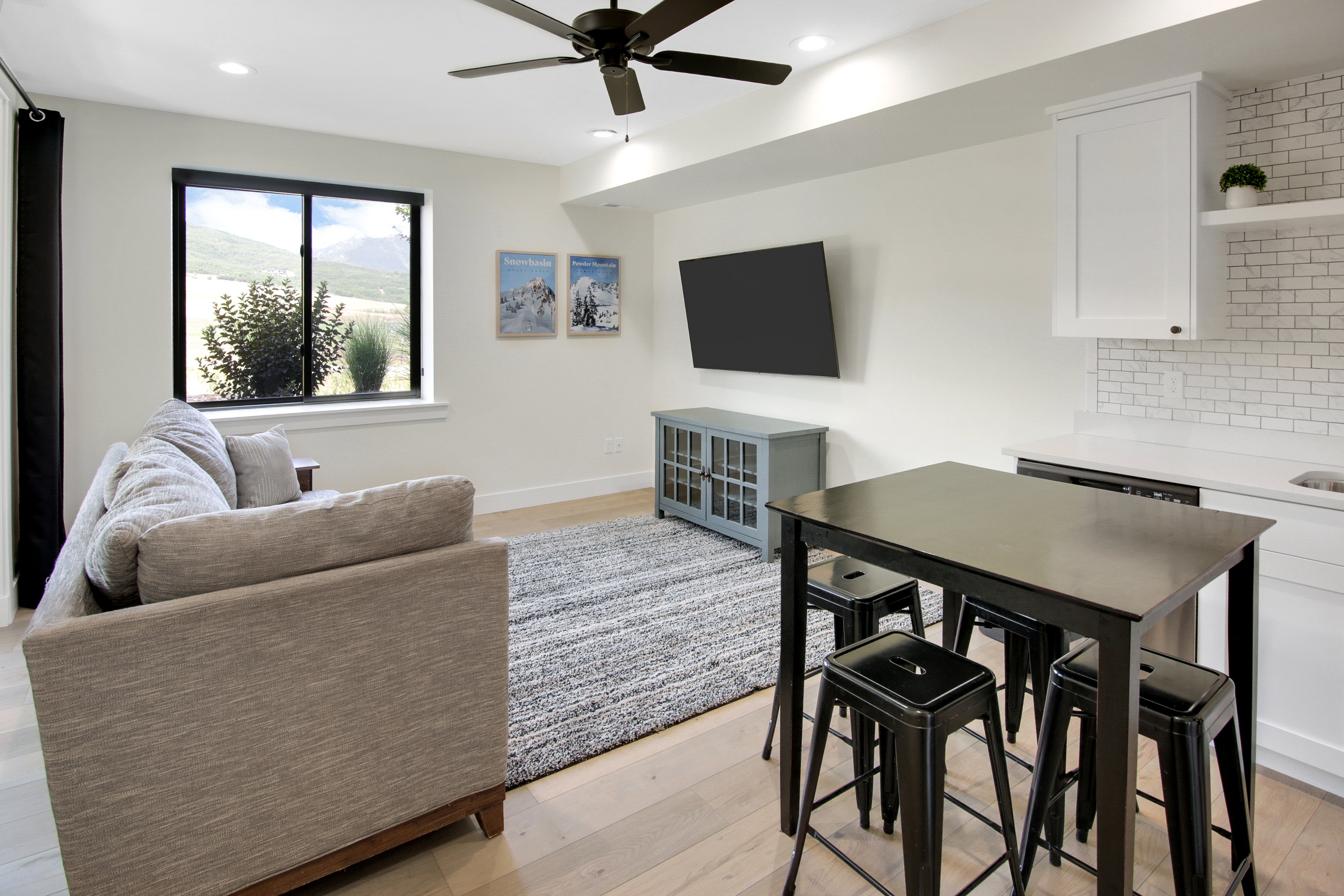 Open-concept living area featuring light wood-finish flooring, recessed lighting, and a ceiling fan