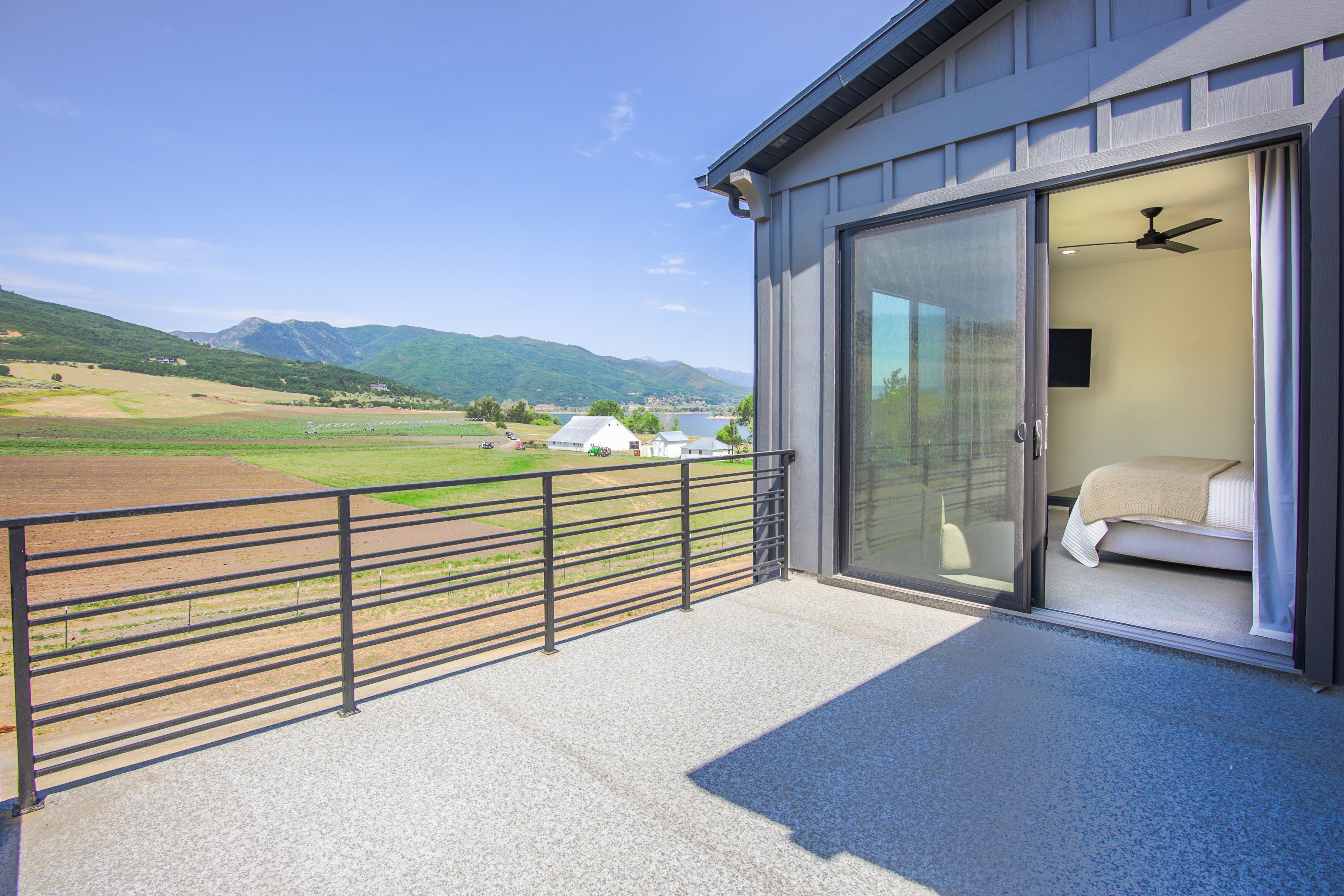Private balcony with a durable aggregate surface and horizontal metal railing