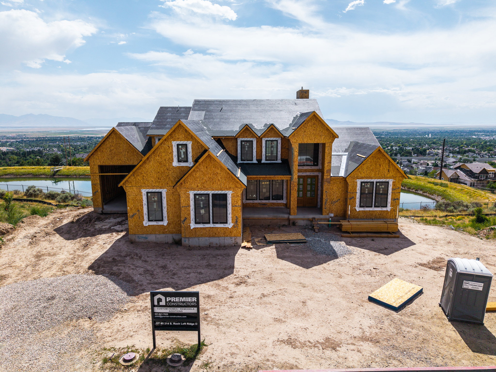 New construction home featuring multiple gables, an attached garage, and black-framed windows