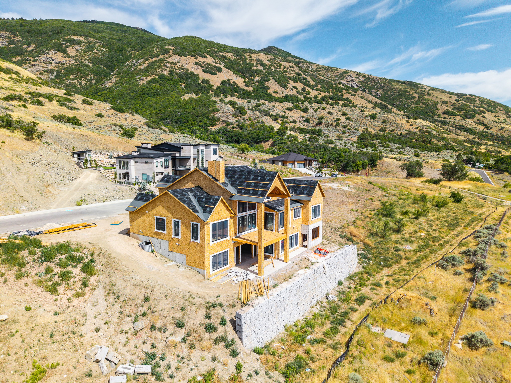 Newly constructed residence featuring multiple gables and a dark shingle roof