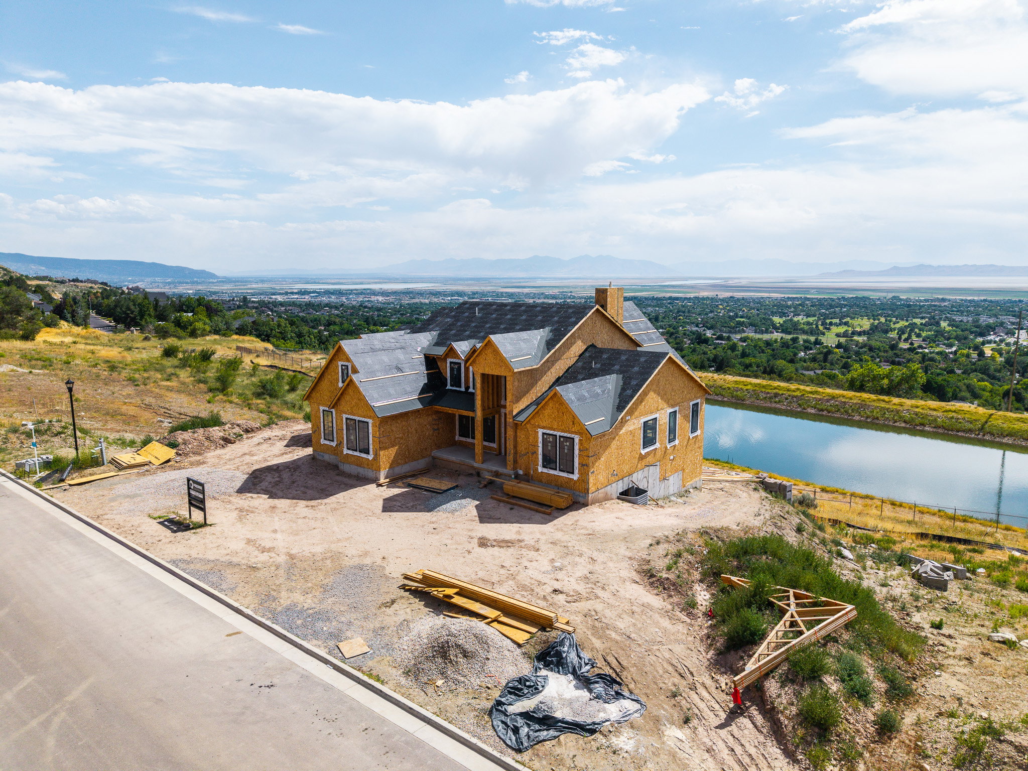 New construction framing with asphalt shingle roofing and an elevated position