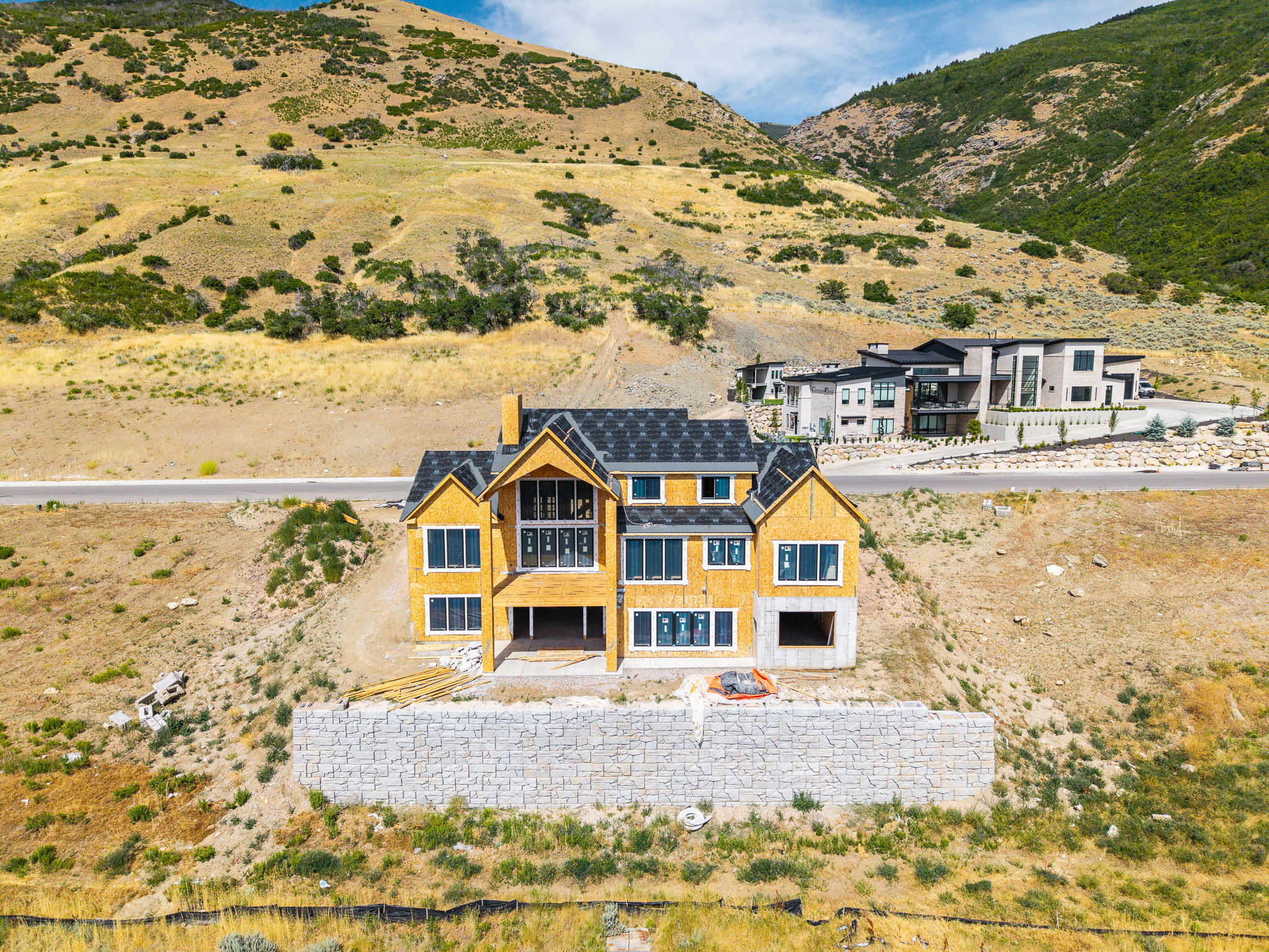 New construction home situated on a hillside lot with mountain scenery