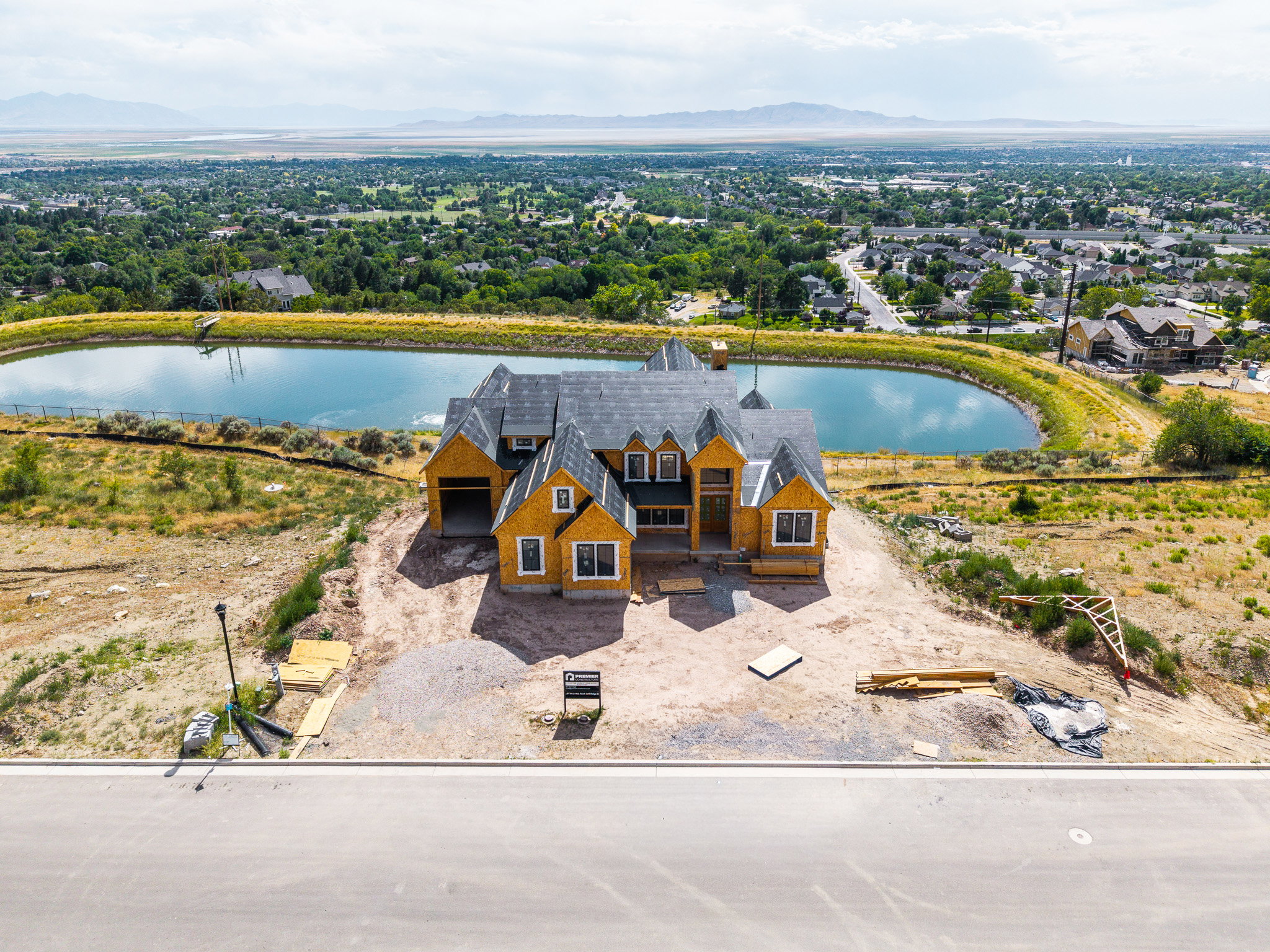 Newly constructed residence featuring a prominent gabled roofline and multiple window dormers