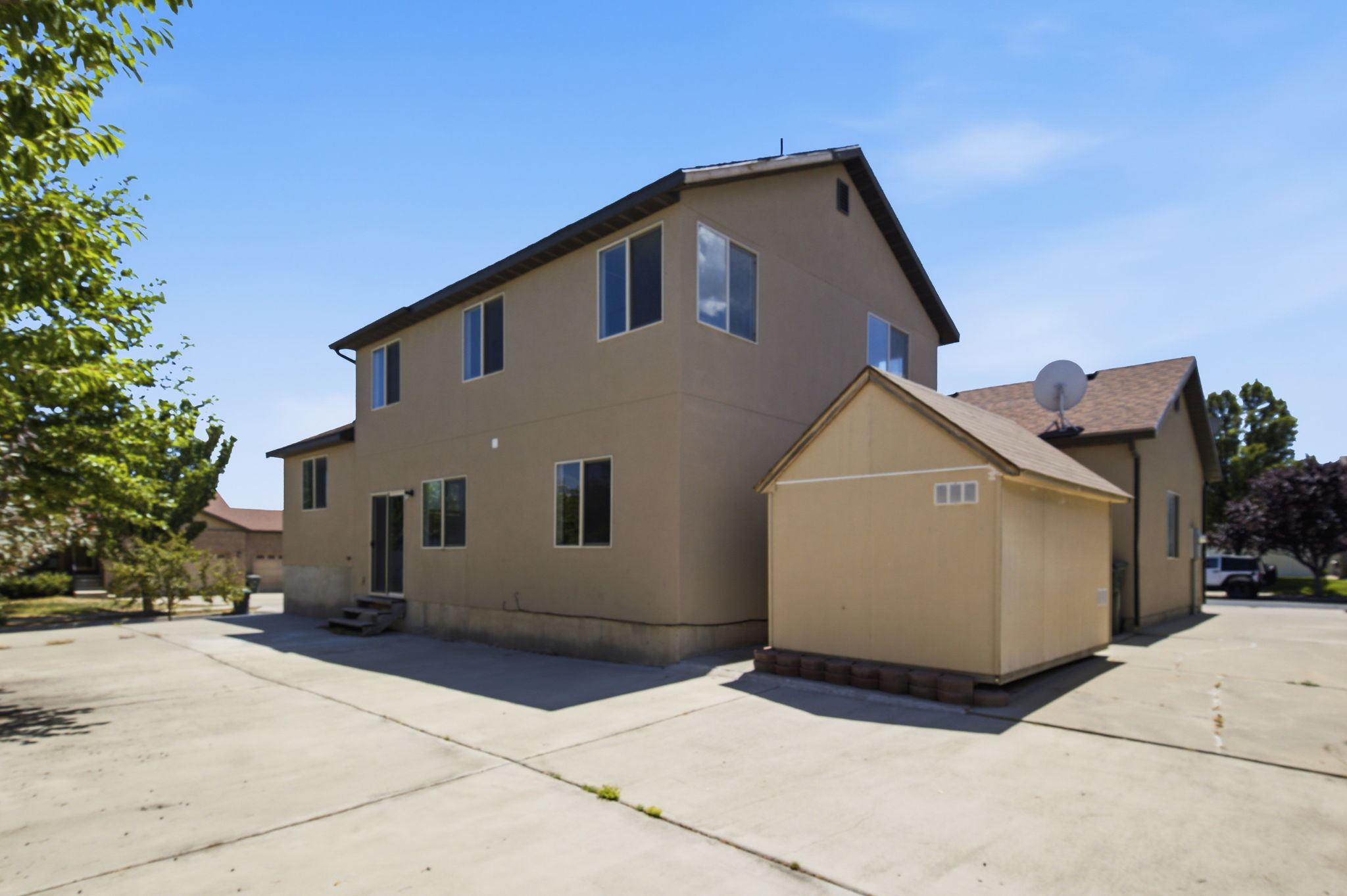 Two-story exterior with stucco siding and multiple windows