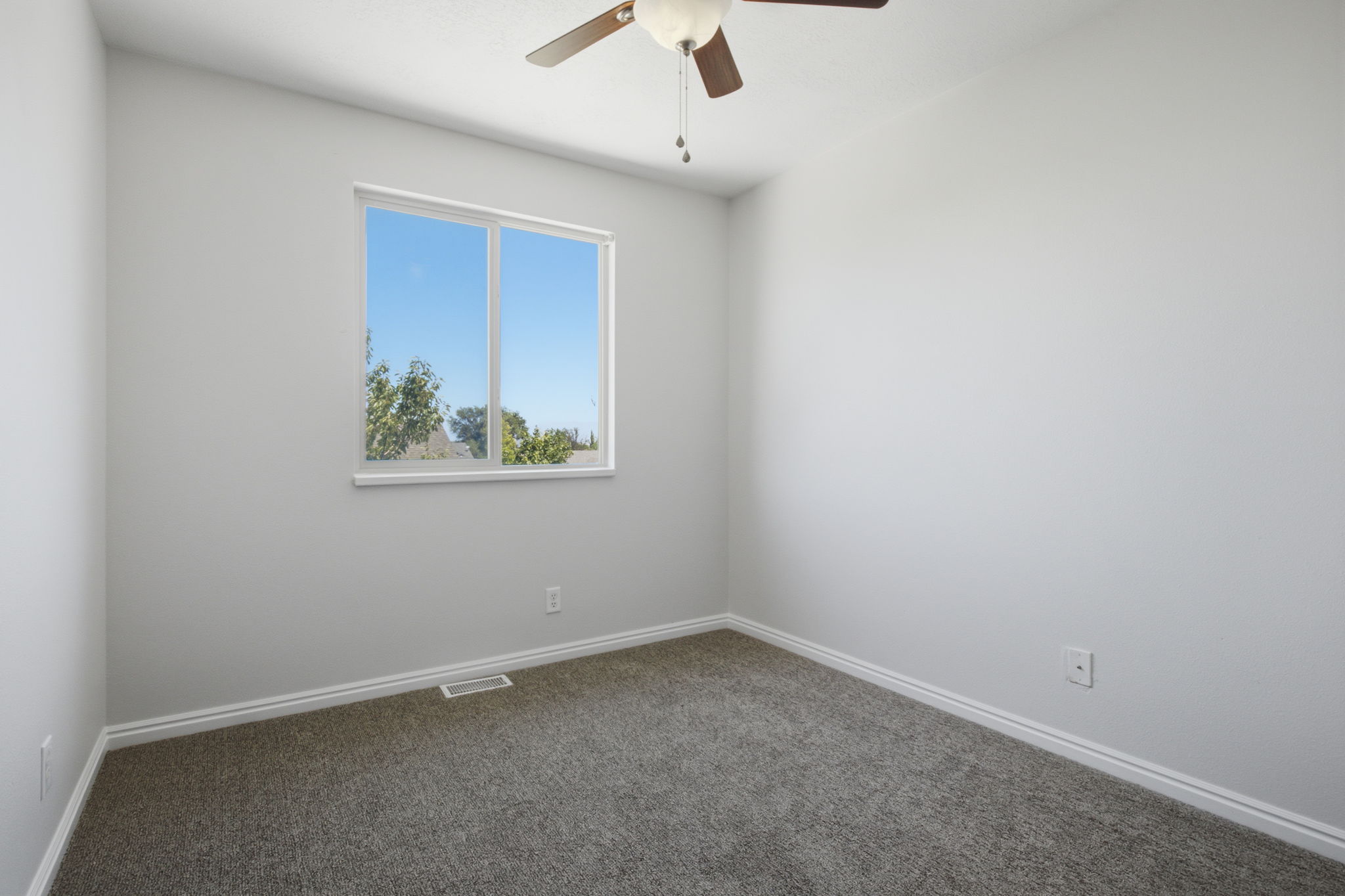 Neutral tone walls with an expansive window offering natural illumination