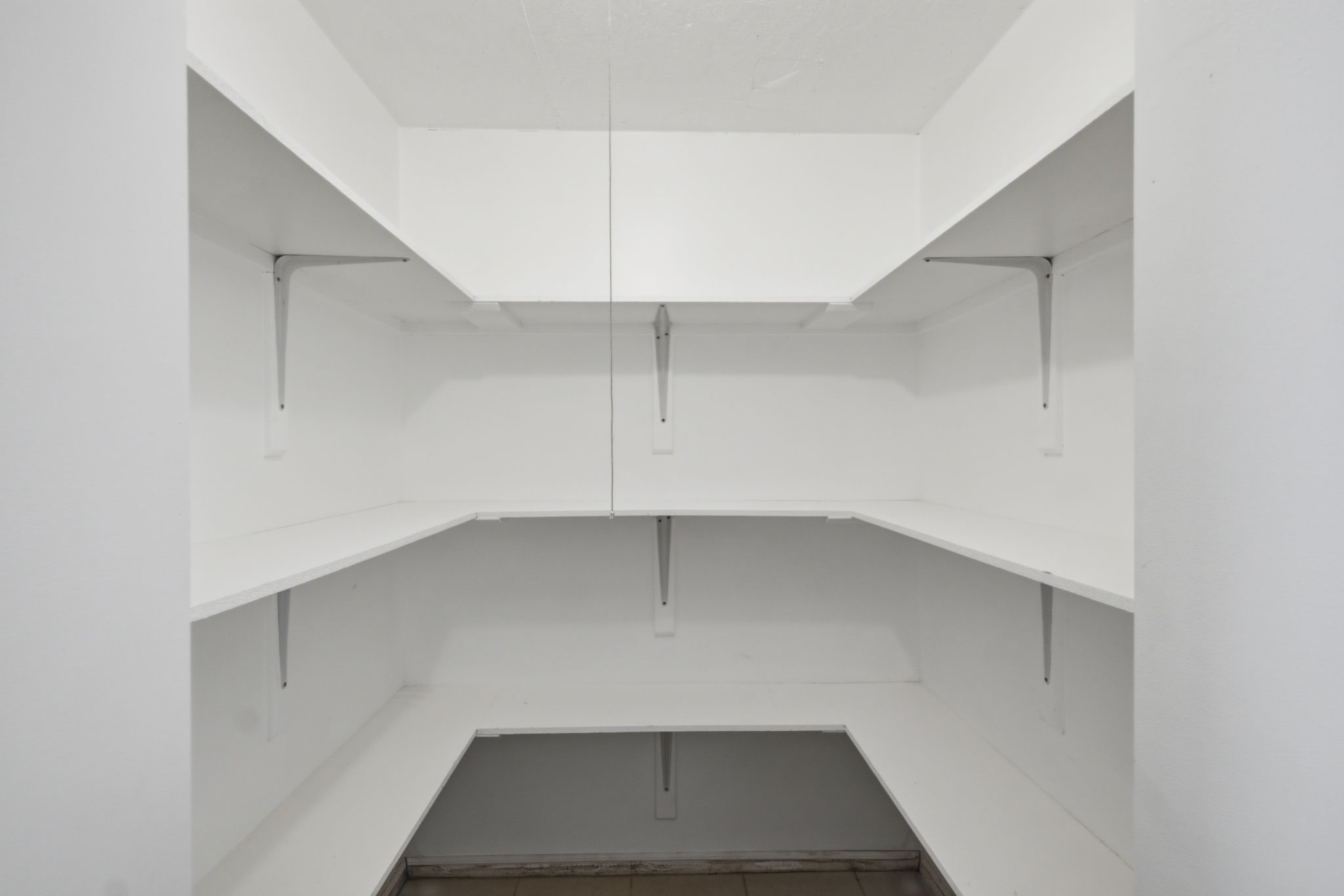 White shelving system with metal brackets