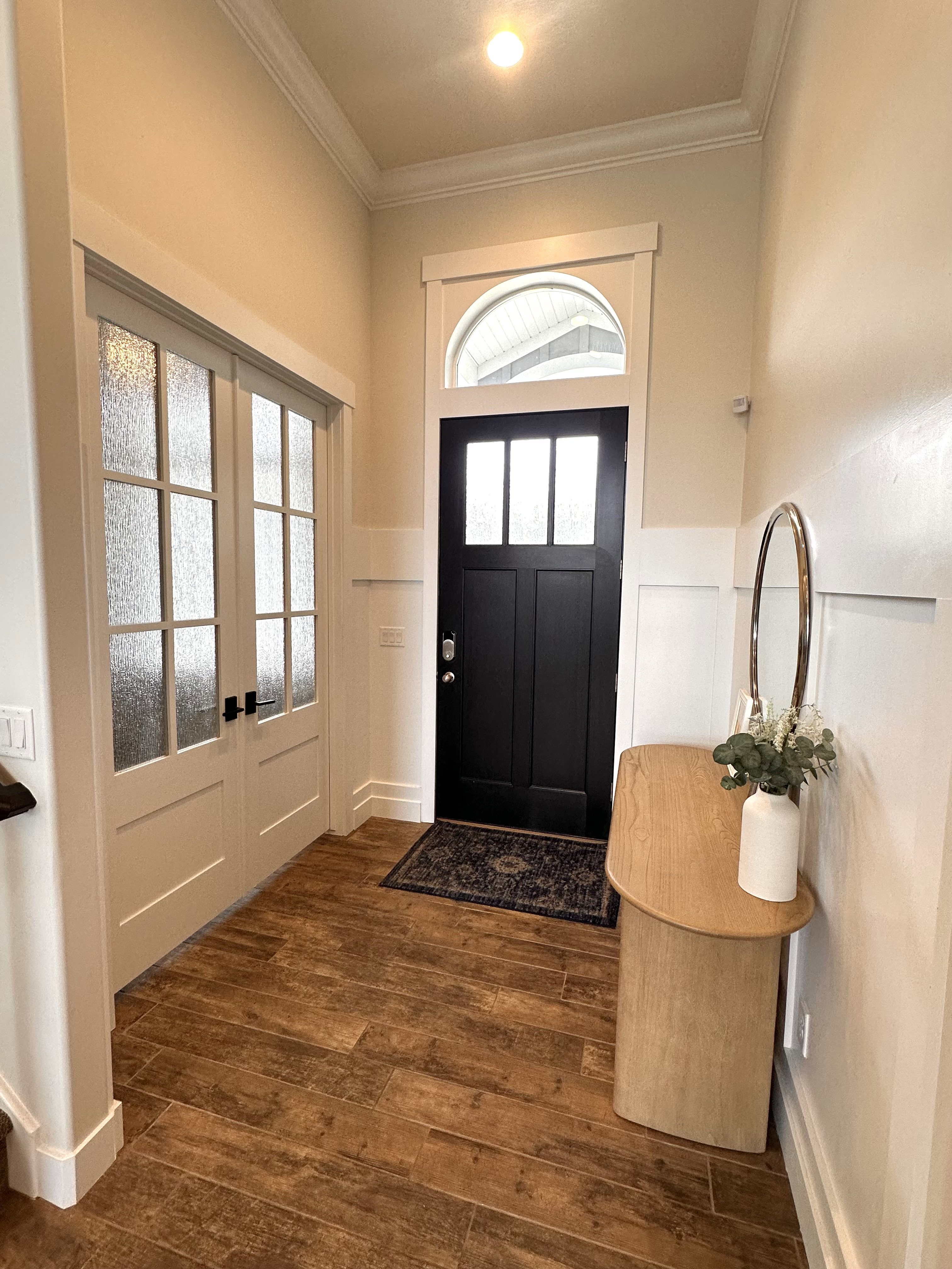 Entryway featuring Tile flooring, wainscoting, and crown molding