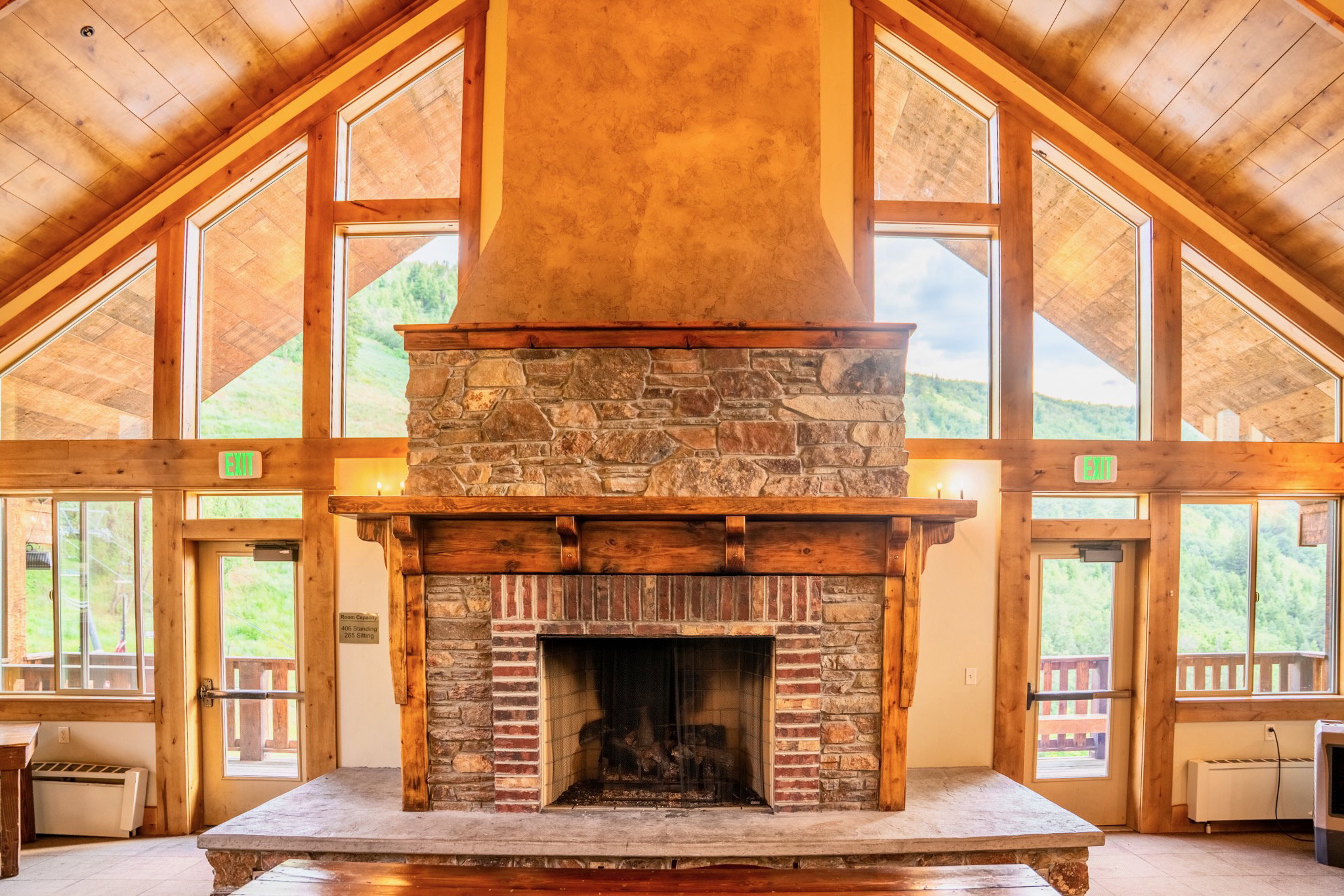 Stone-clad fireplace with a timber mantel