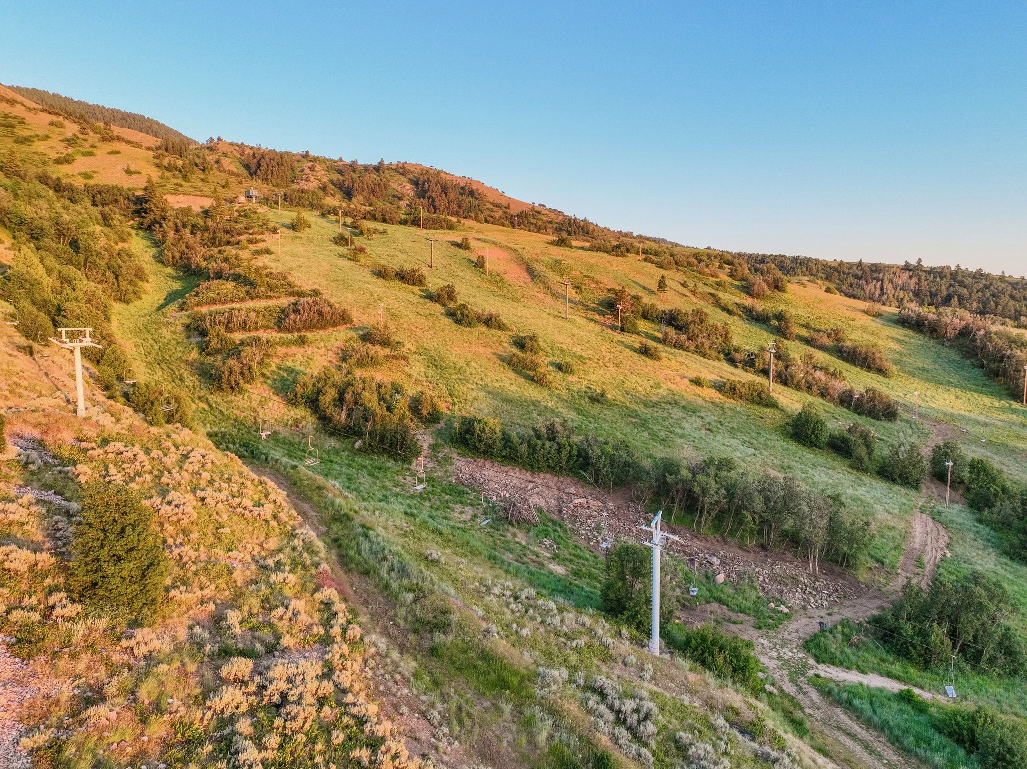 Mountainous terrain with varied foliage and ski lift infrastructure