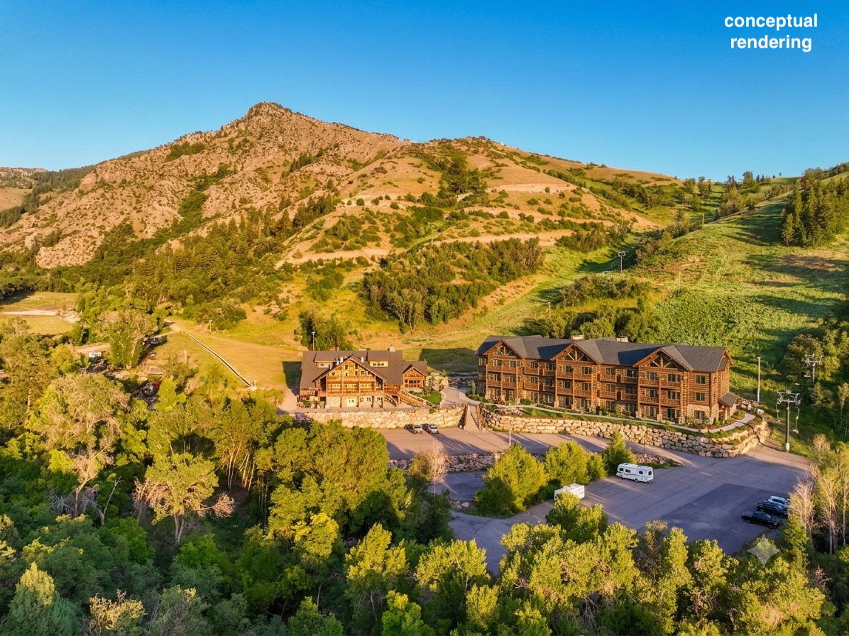 Mountain property featuring multiple multistory buildings with wood siding and stone accents, surrounded by mature trees and a paved parking area, all situated at the base of a verdant mountain