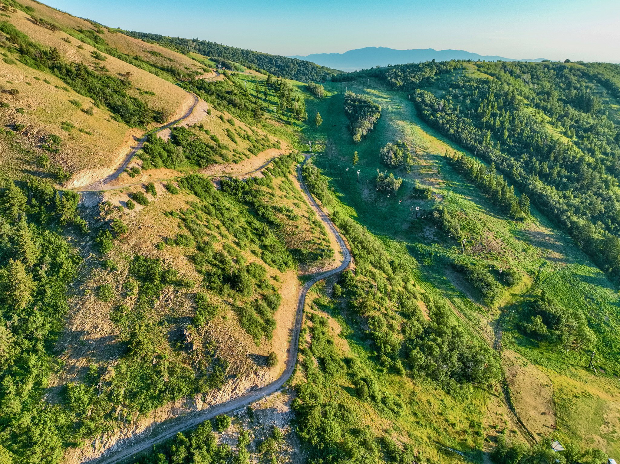 Expansive mountain terrain featuring natural landscaping and winding trails