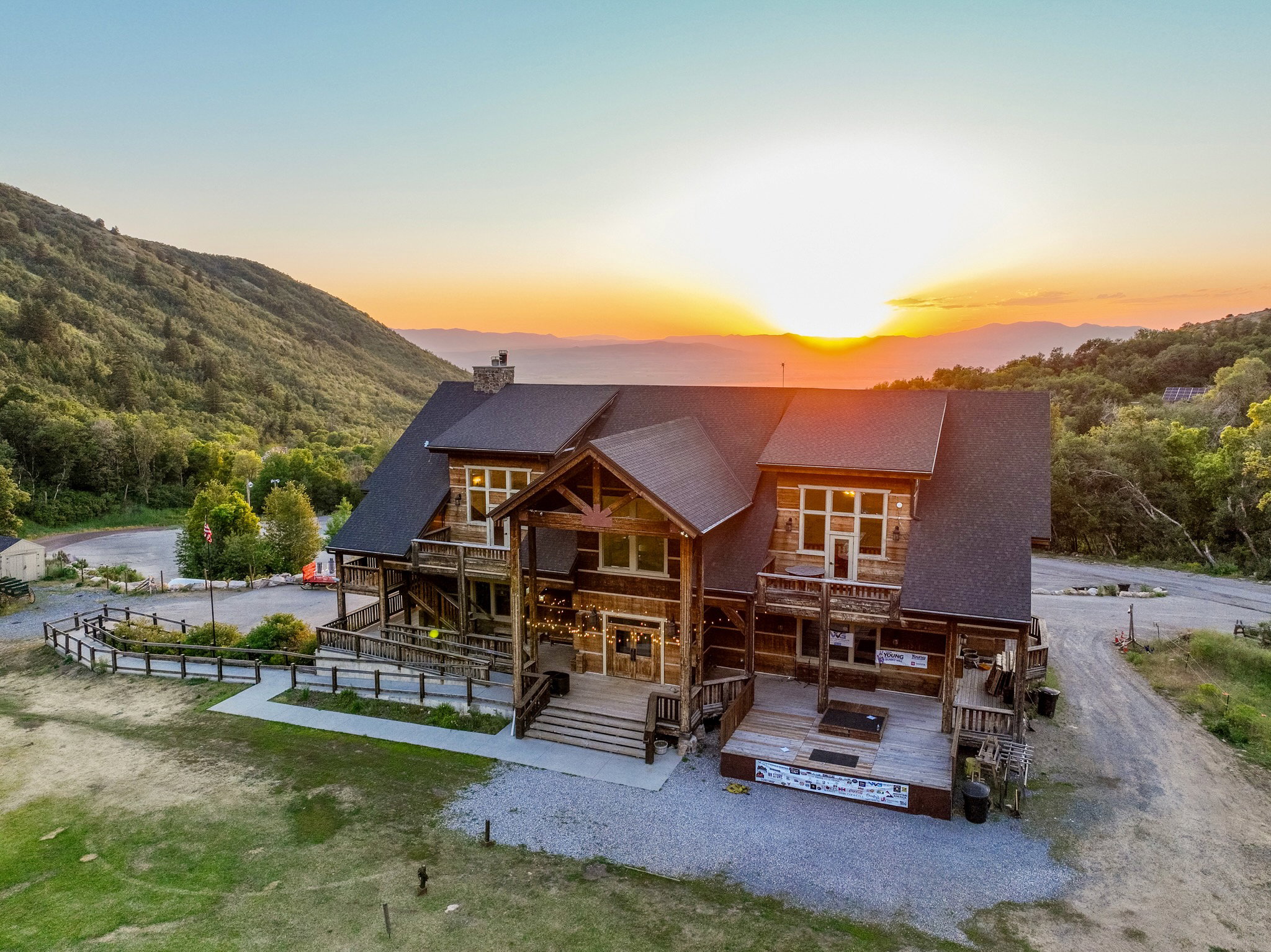 Expansive rustic-style lodge featuring multiple balconies and a large outdoor deck