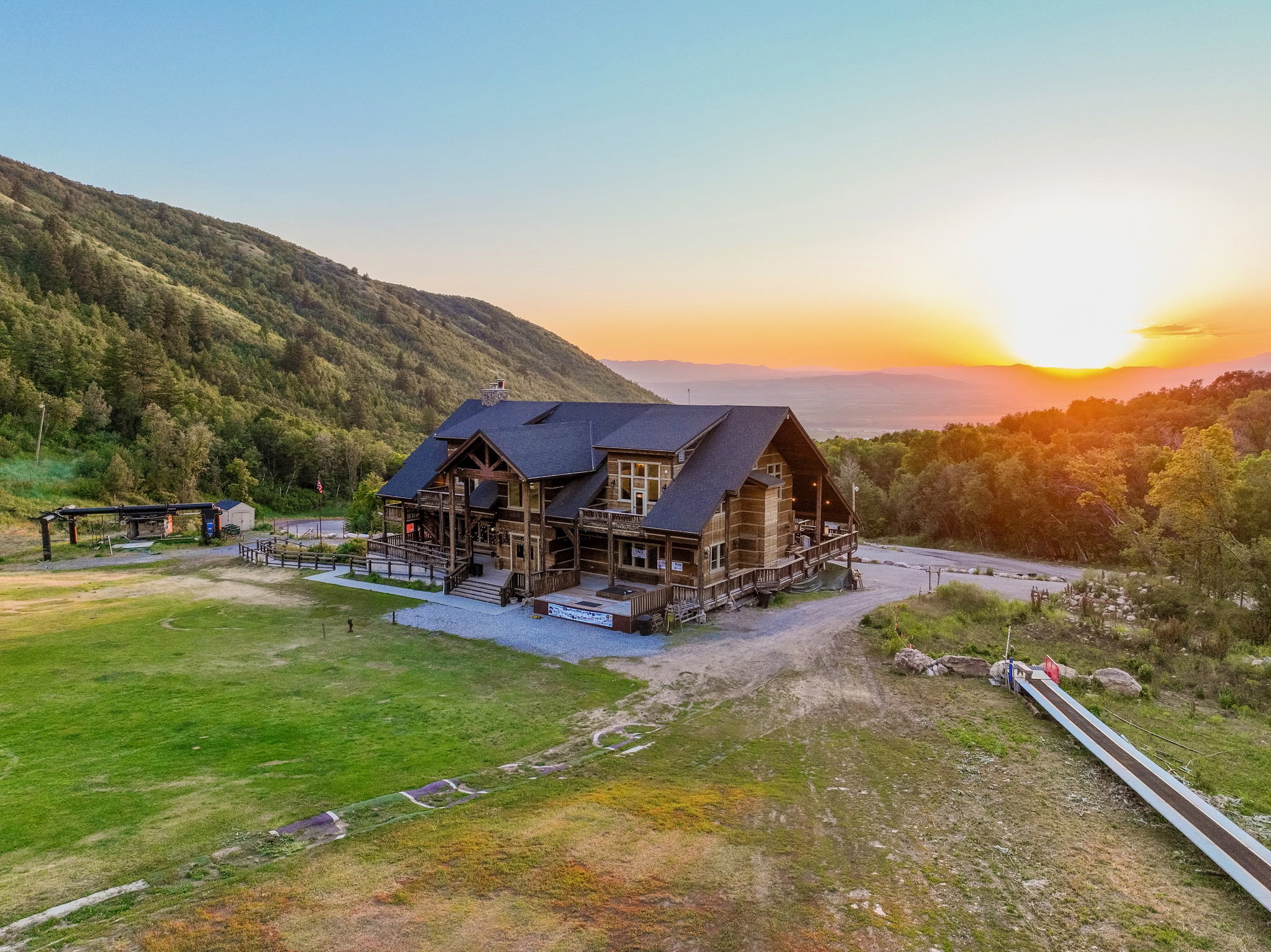 Expansive mountain property featuring a multi-level structure with natural wood siding and a dark roof