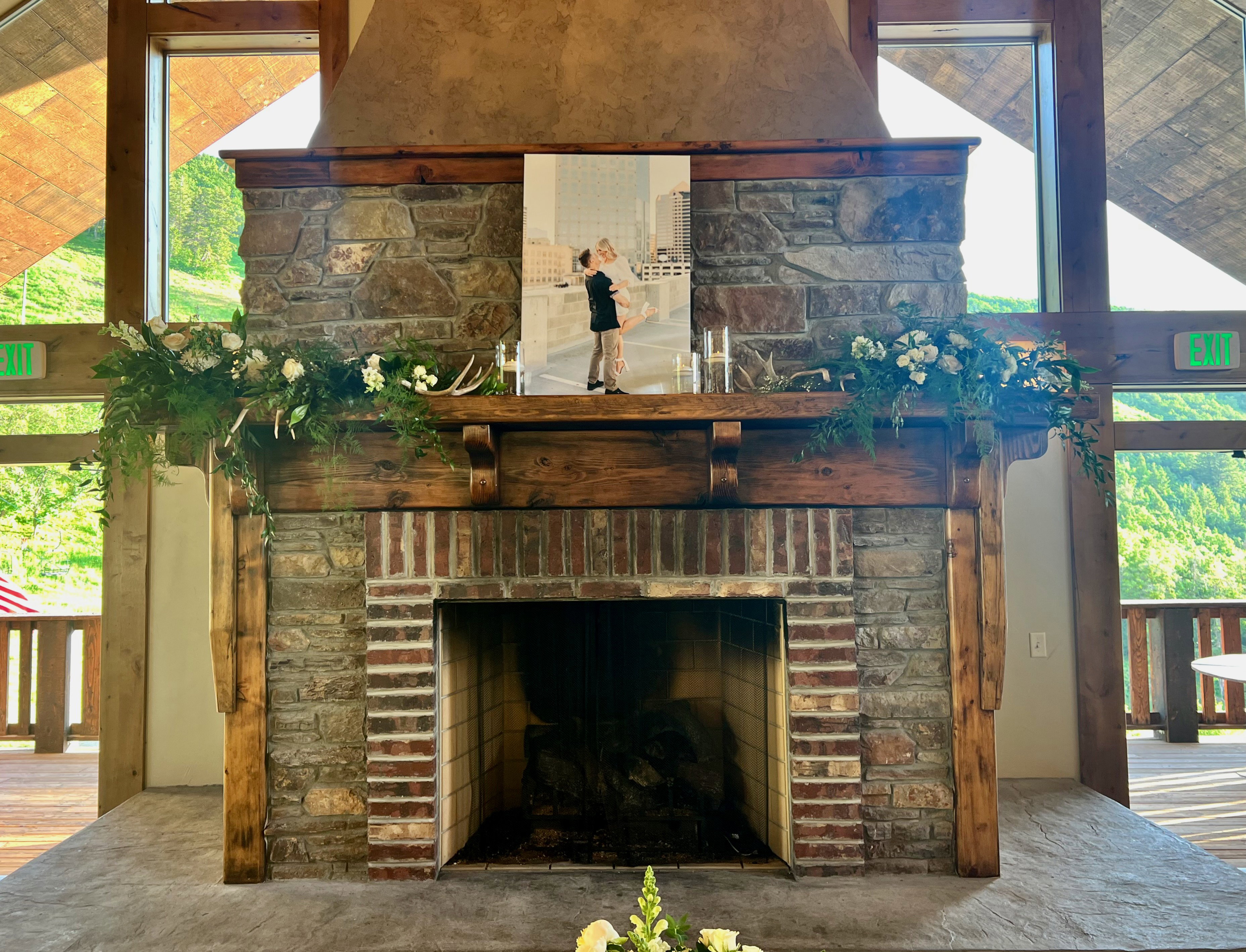 Stone-clad fireplace with a prominent wood mantel and brick firebox surround