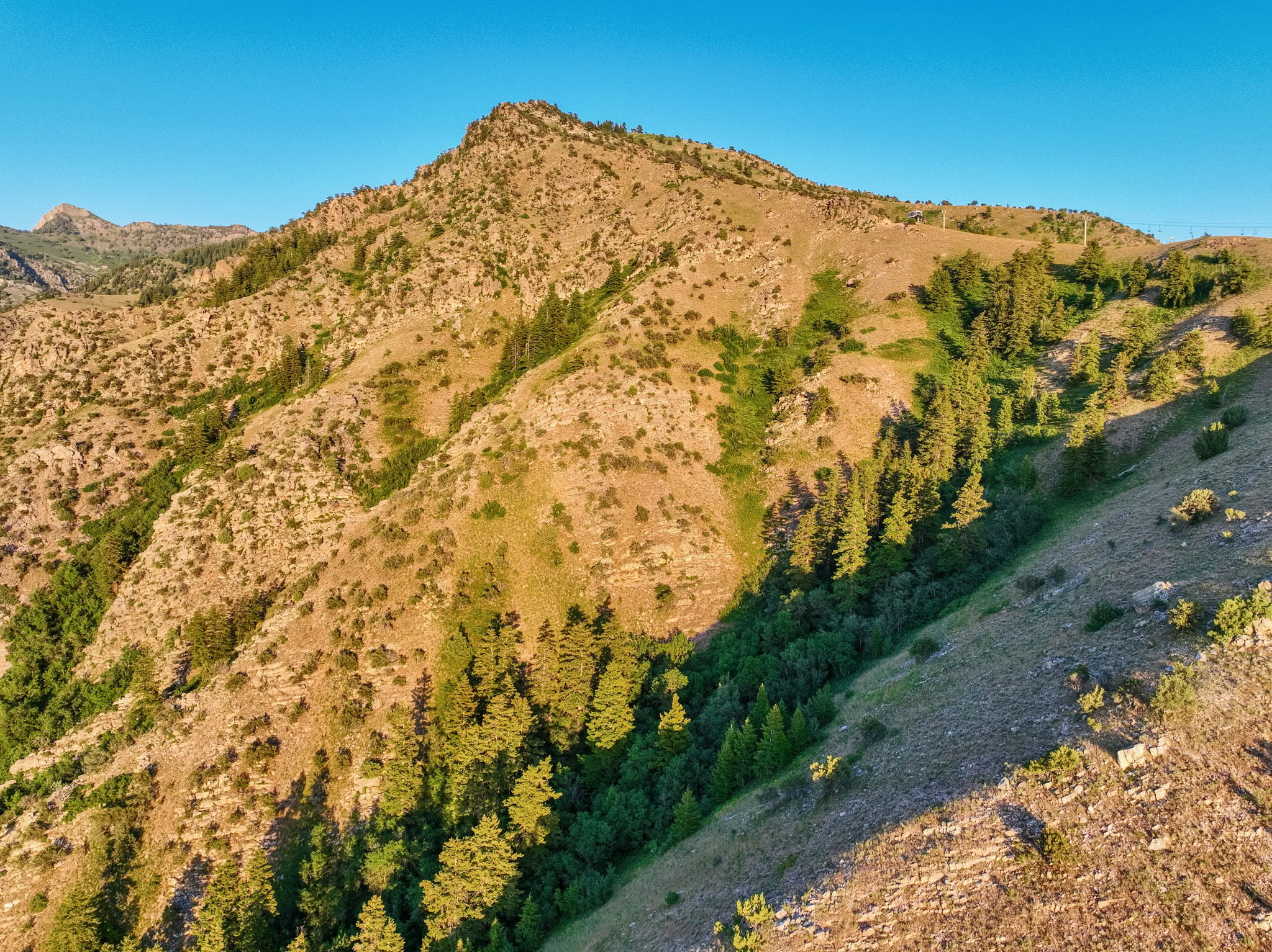 Mountainous terrain with varied elevations and natural vegetation