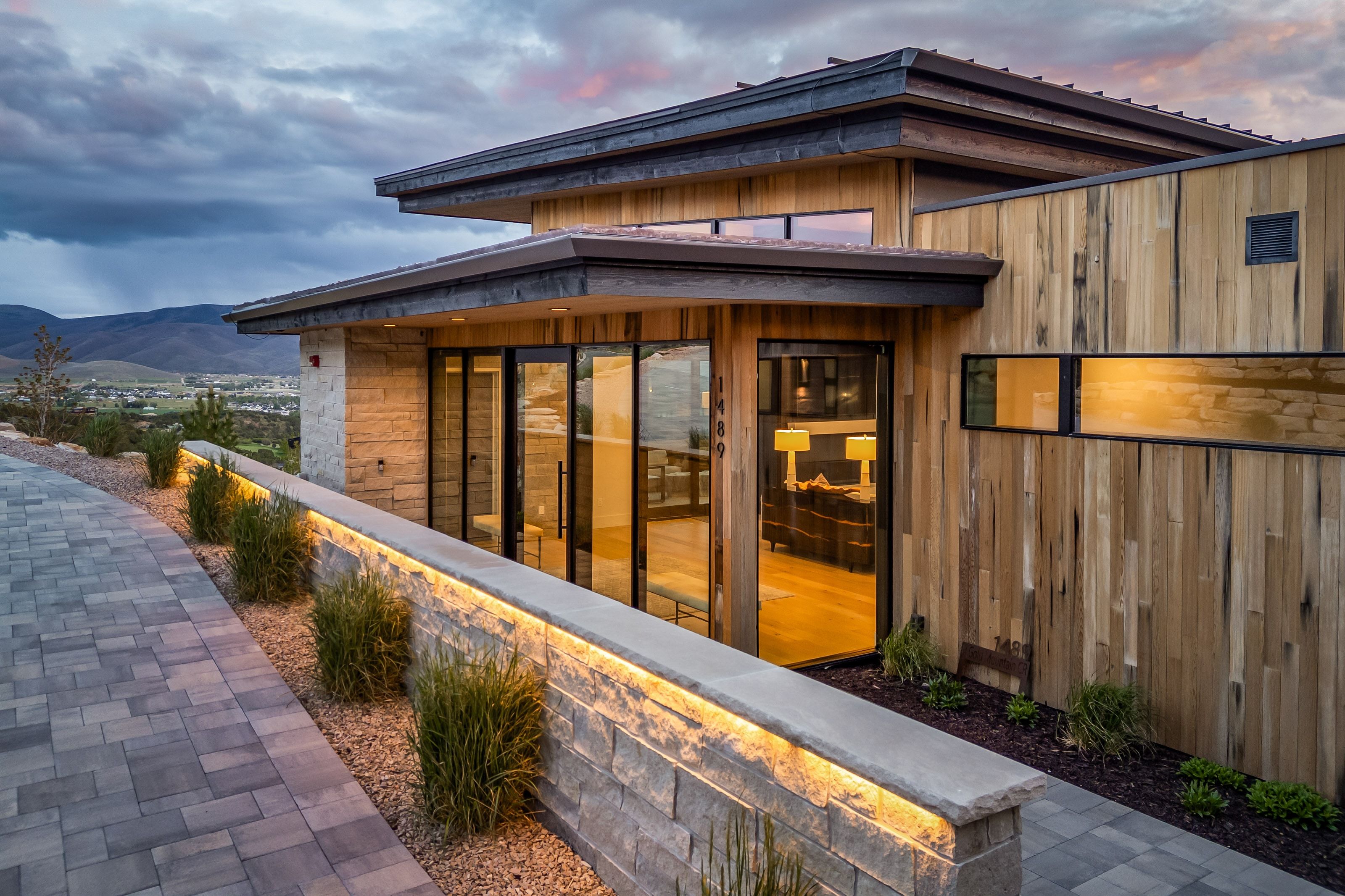 Modern exterior featuring natural wood siding and stone accents