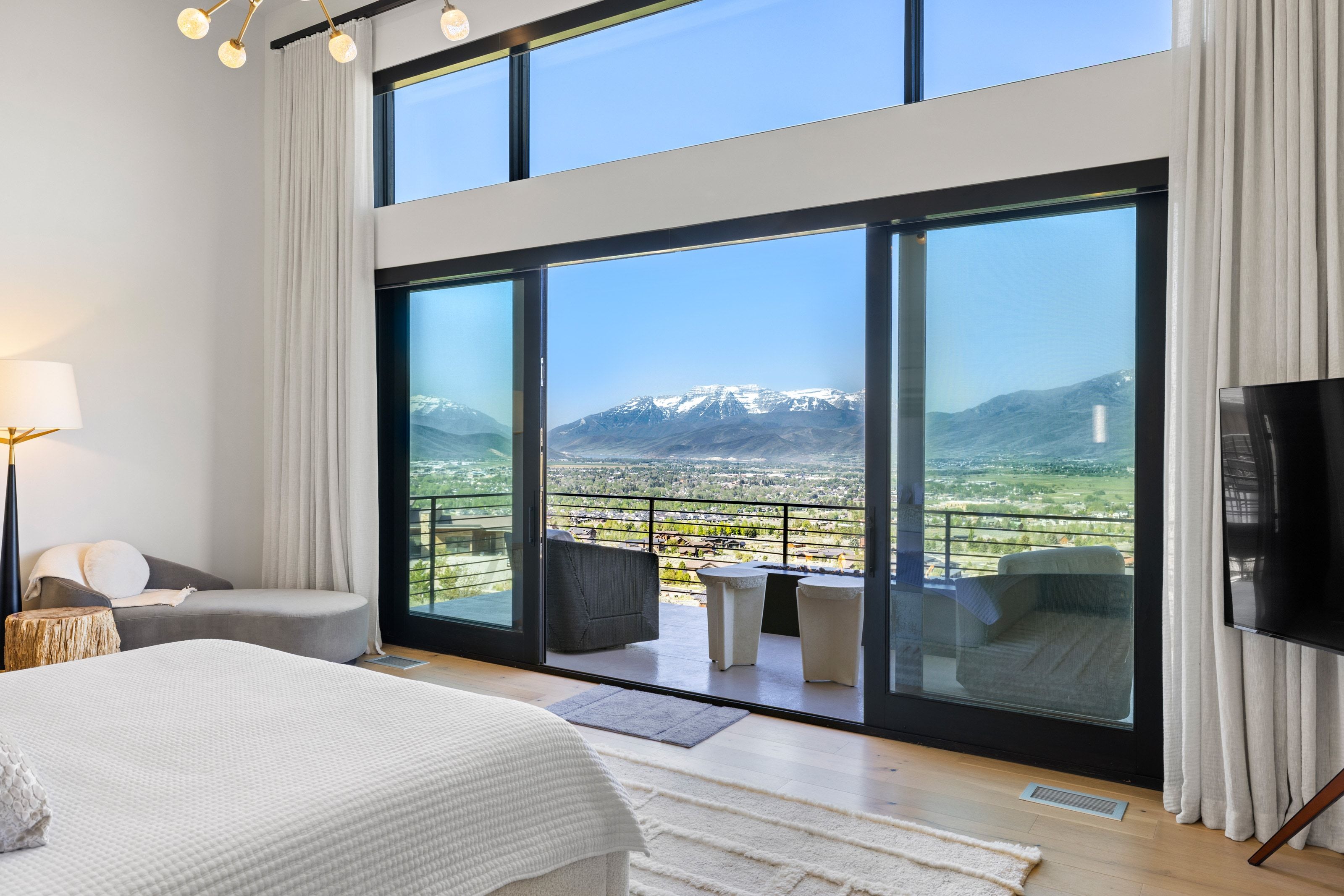 Expansive sliding glass doors provide access to a private balcony