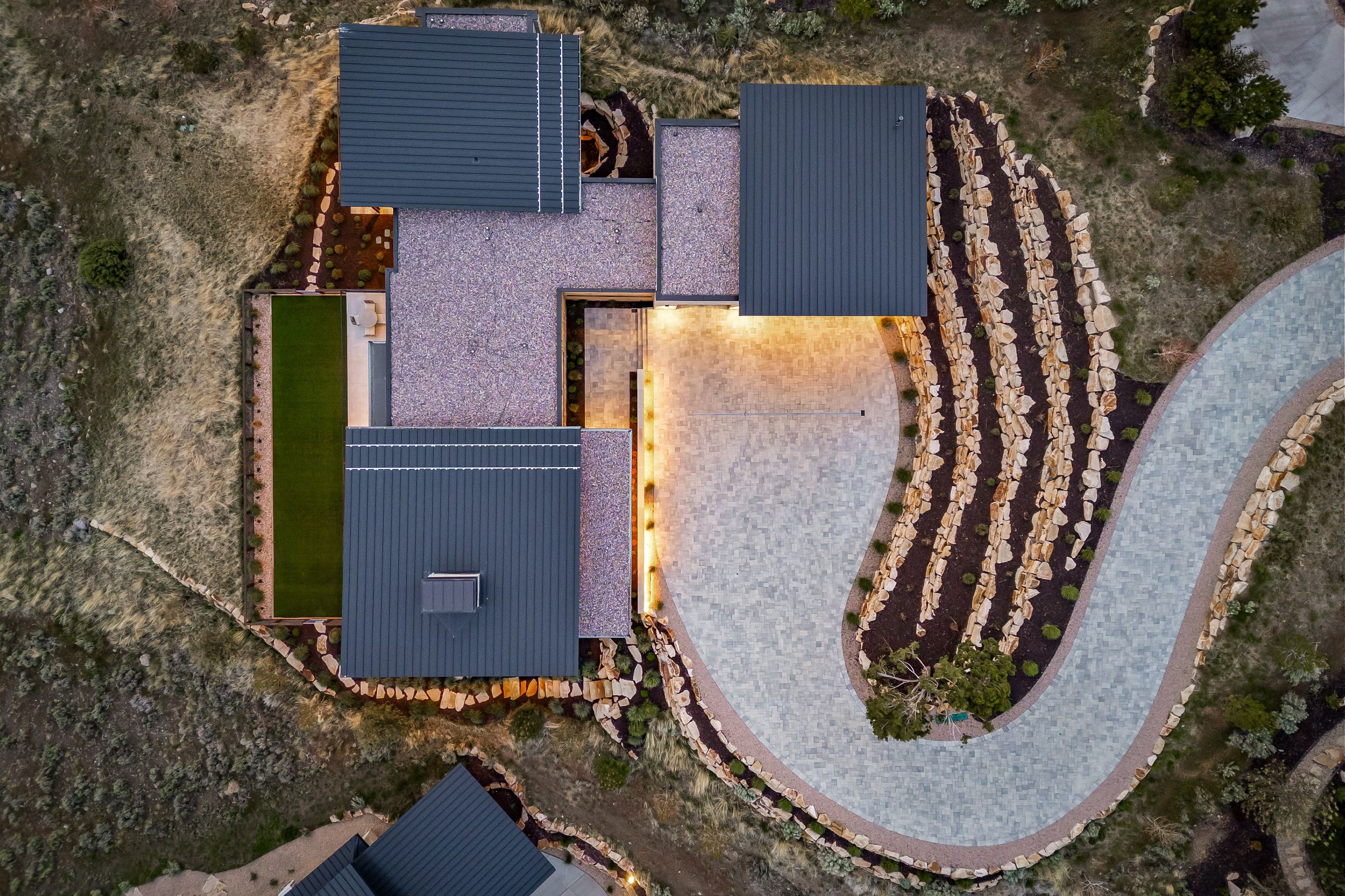 Modern architectural design featuring dark grey metal roofing