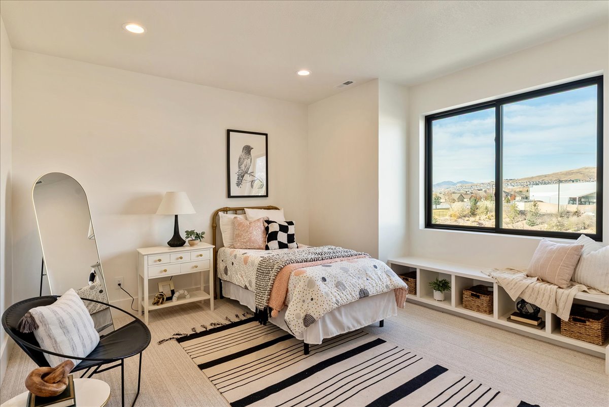 Bright room featuring a large black-framed window with exterior scenery, recessed lighting, and light-toned flooring
