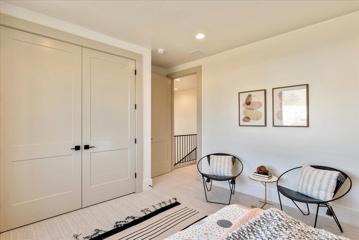 Double panel doors with matte black hardware, recessed lighting, and neutral wall tones