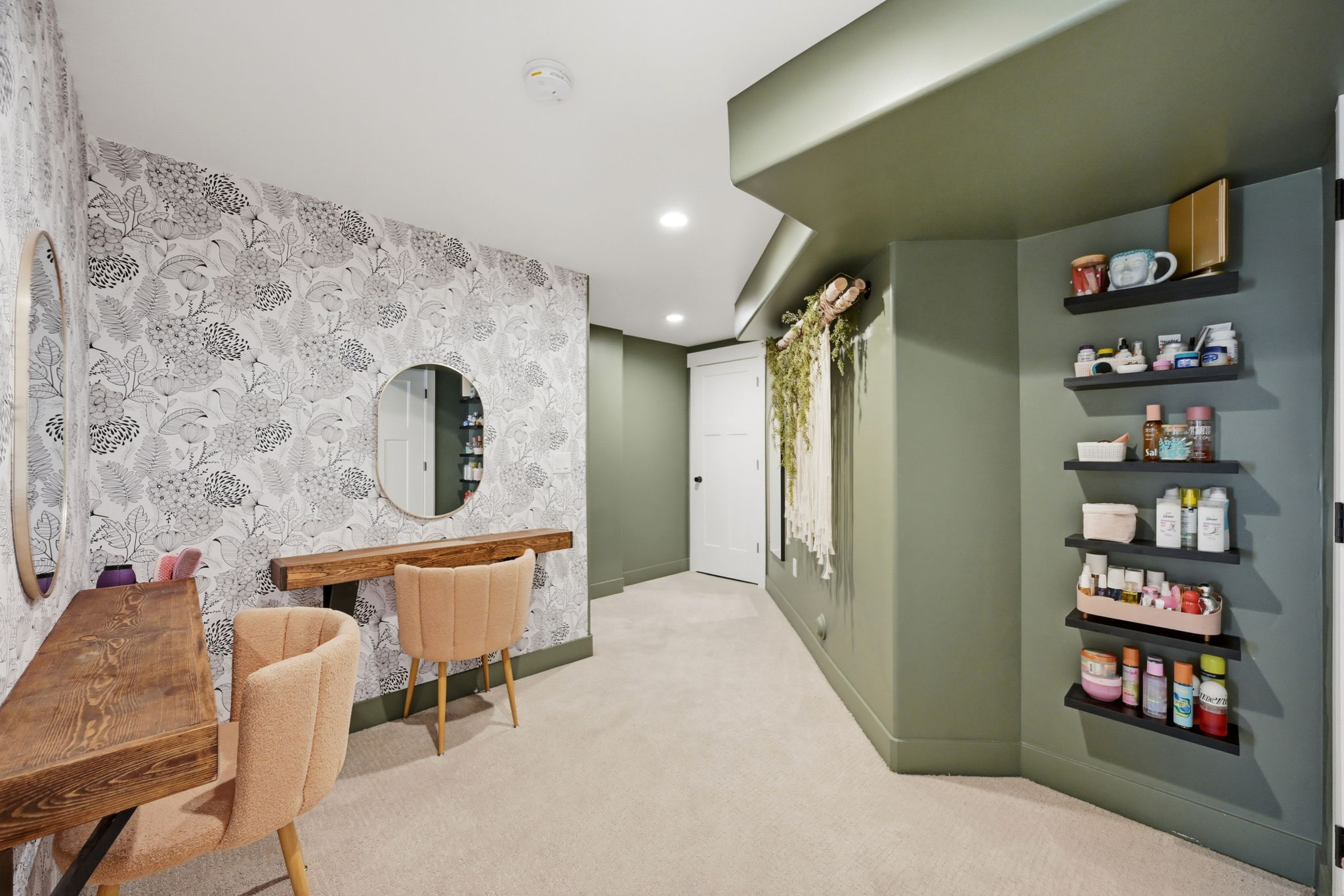 Accent wall featuring botanical pattern wallpaper and built in desks/vanities