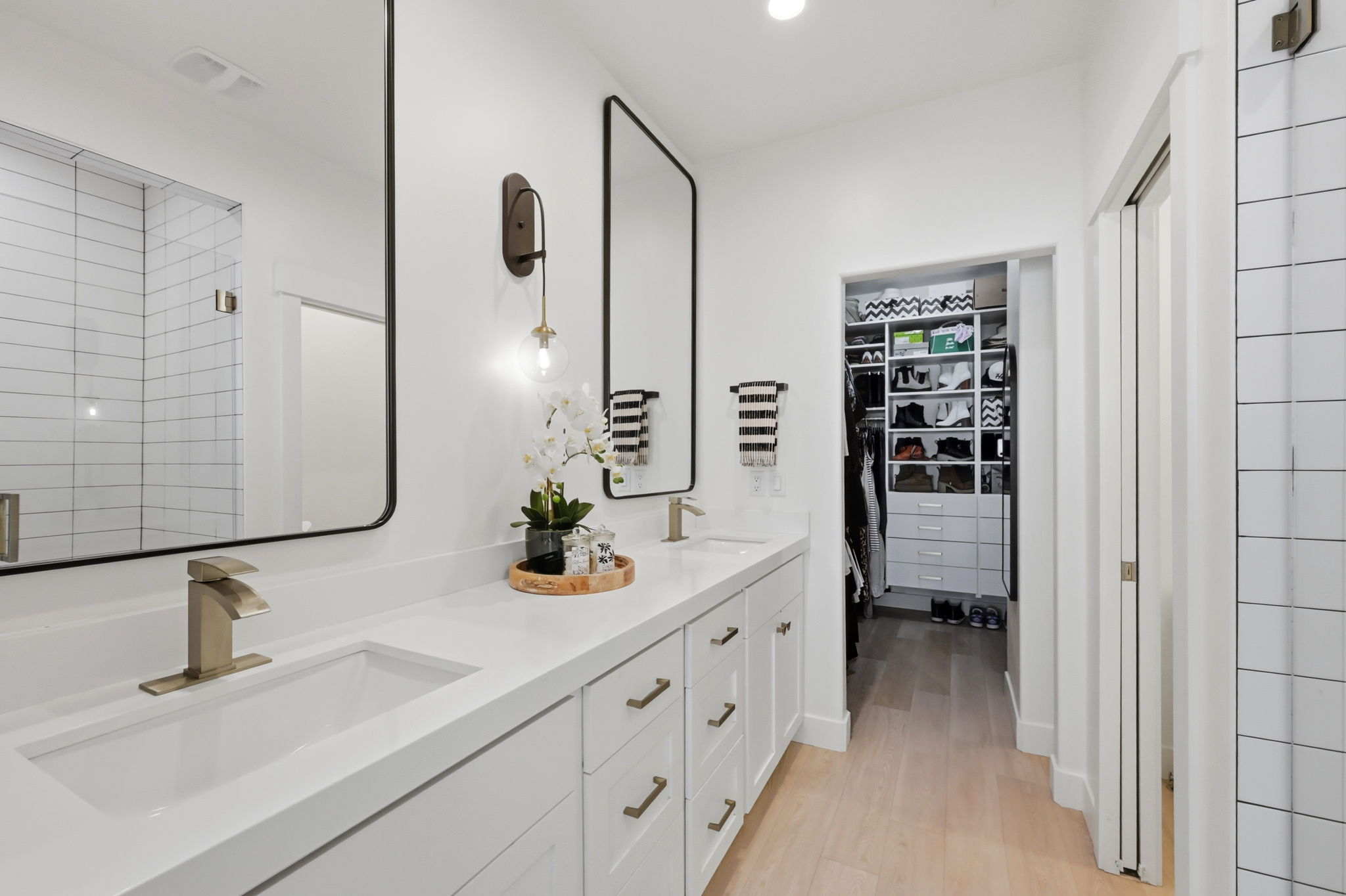 Ensuite bath with dual vanity with undermount sinks, quartz countertop, and brushed nickel fixtures