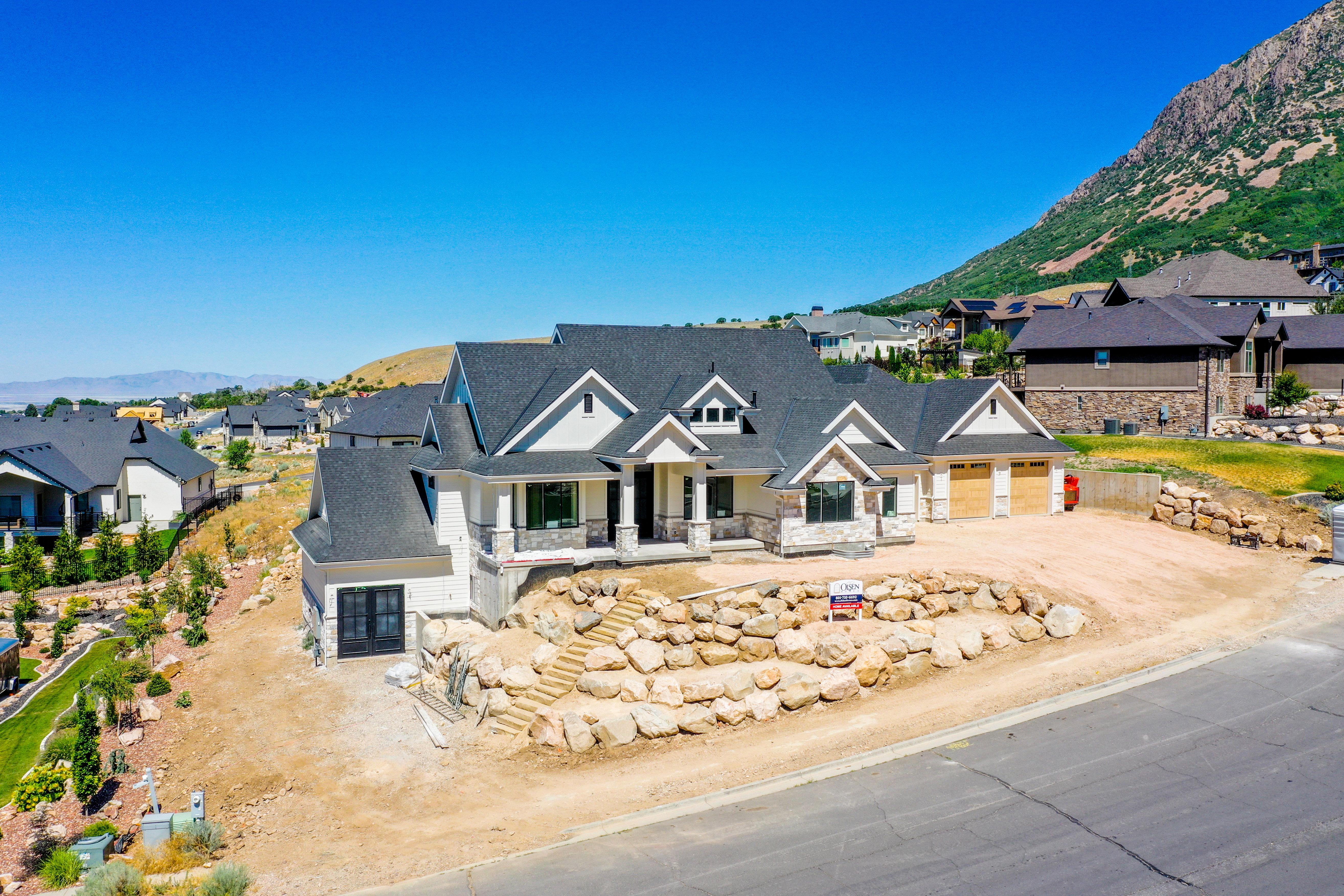 Contemporary residence featuring multiple gables and a stone and siding facade