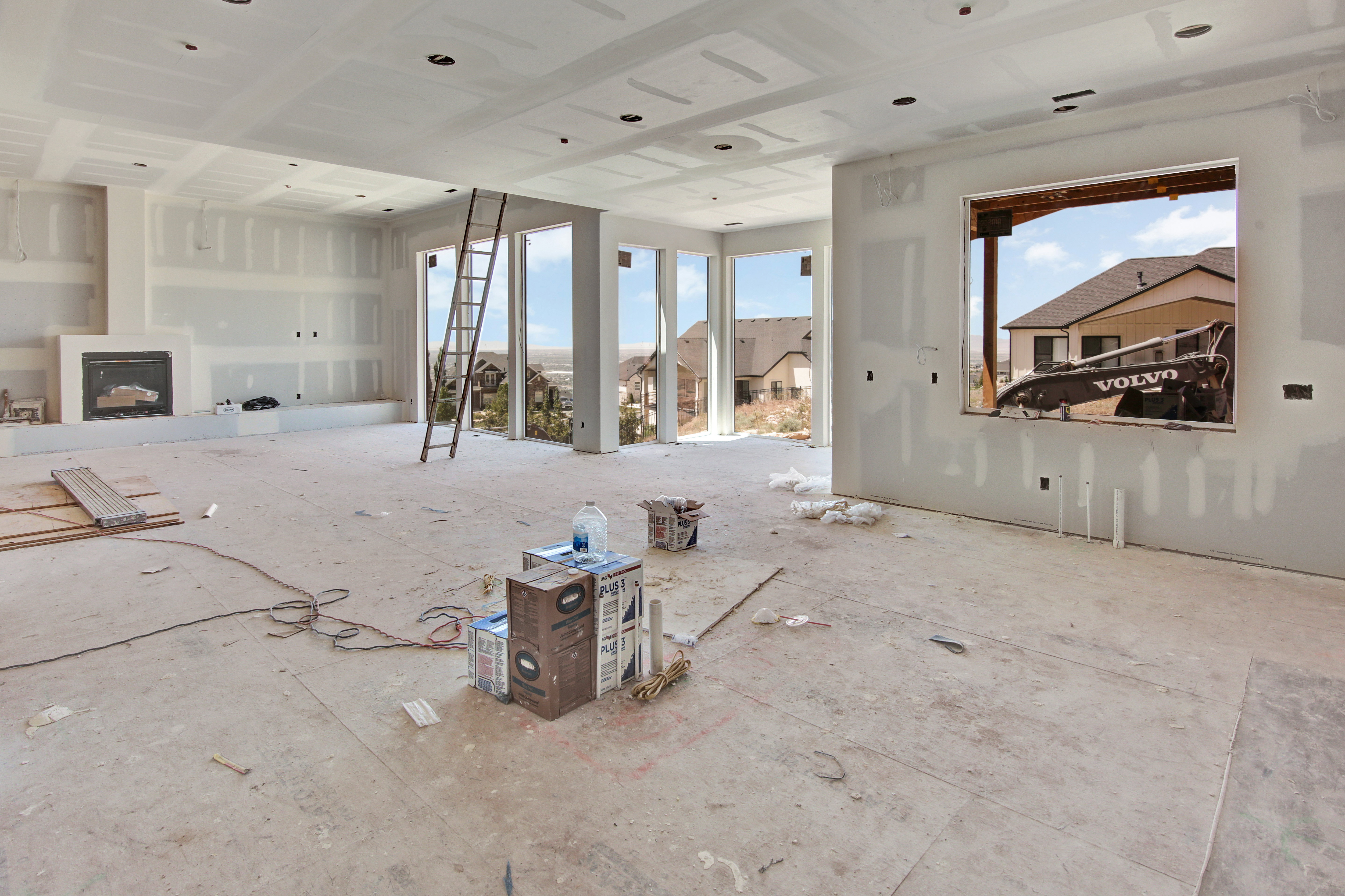 Spacious interior featuring a built-in fireplace, multiple large windows, and a coffered ceiling